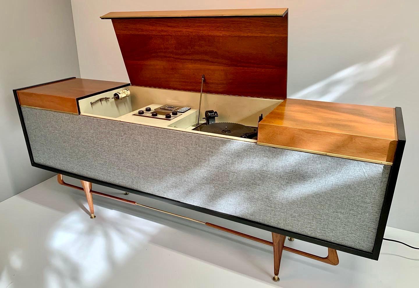 Spectacular midcentury console made in Mexico in the early 1960s, mahogany wood with brass details. We added new Bluetooth audio equipment as the original system we believe does not work. The entire exterior was professionally restored.