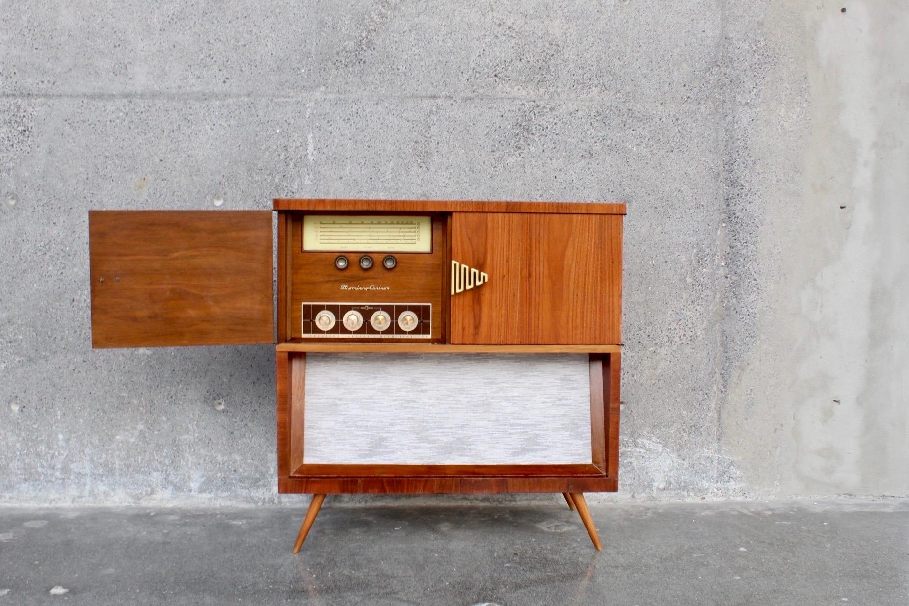 Spectacular mid-century console made in the early 1960s, all in walnut wood with some details in root veneer. We added new Bluetooth audio equipment as the original system we believe does not work. The entire exterior and interior was professionally