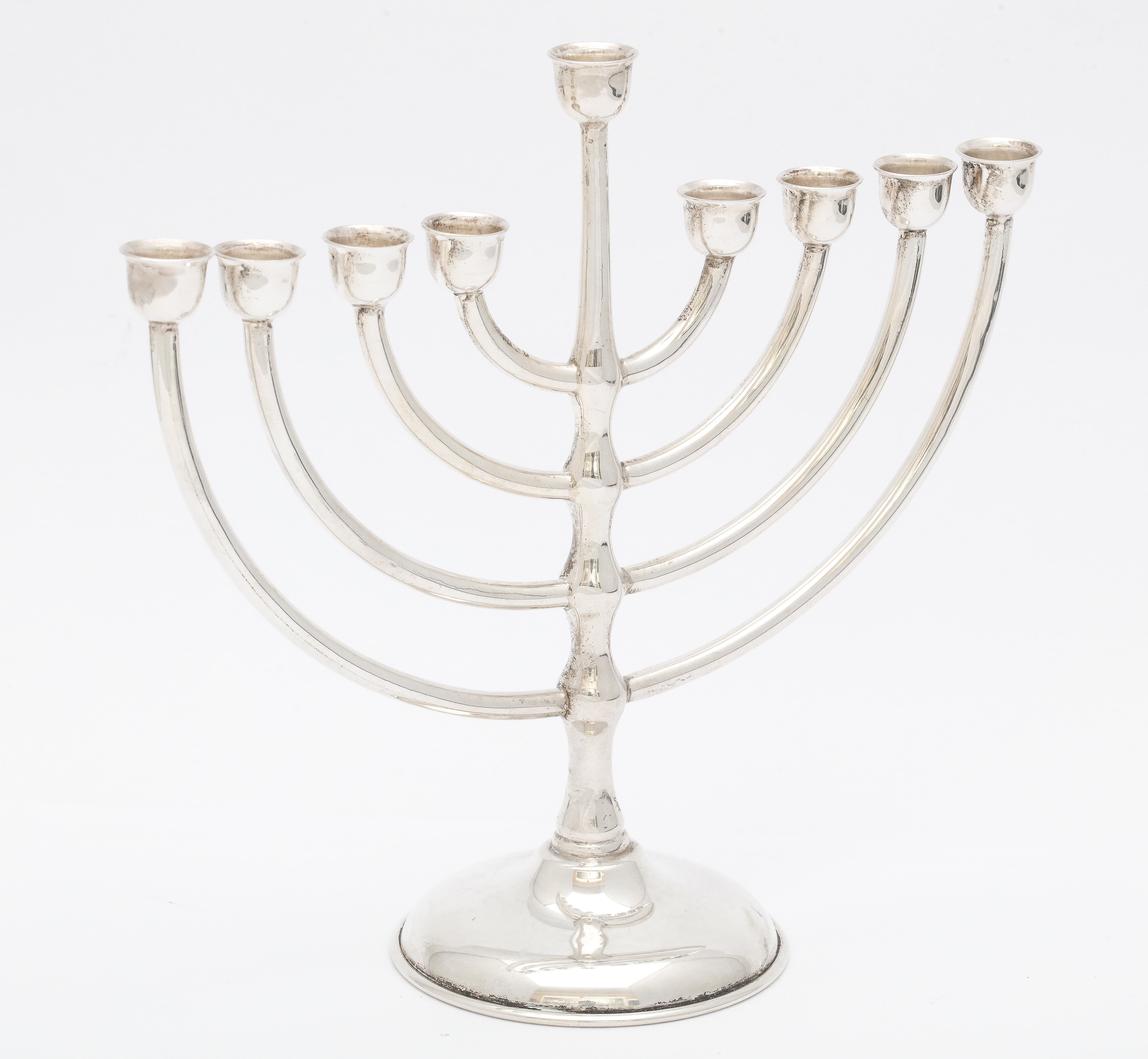 Mid-Century Modern, sterling silver menorah, Mexico, circa 1950s. Measures: 5 3/4 inches high (at highest point) x 6 inches wide (at widest point) x 2 1/2 inches diameter (across base). Not weighted - weighs 3.985 troy ounces. Dark spots in photos