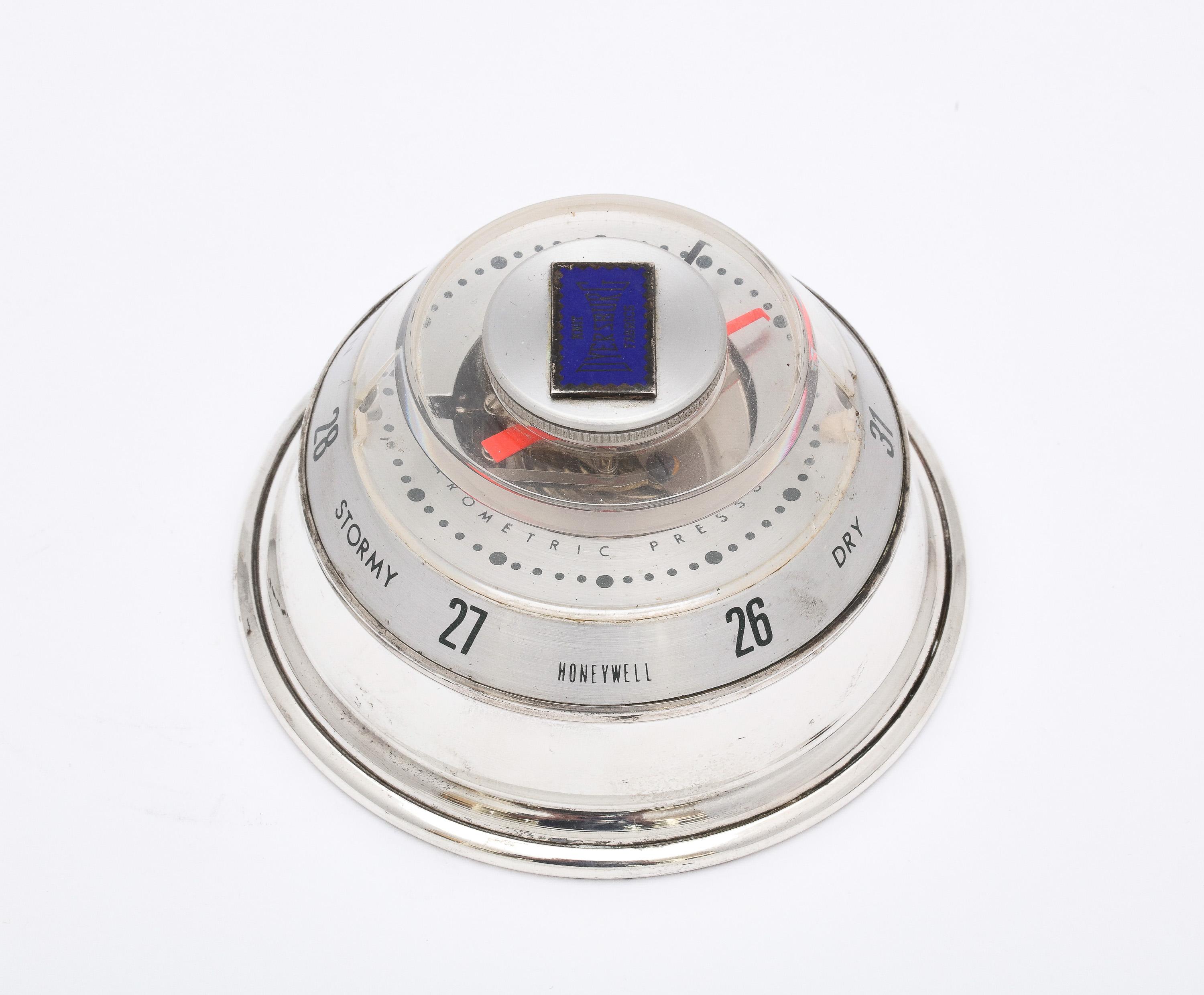 Mid-Century Modern, sterling silver-mounted Honeywell barometer, Baldwin and Miller Co., Indianapolis, Indiana, Ca. 1950's. Barometer mechanism itself is made by the Honeywell Company. Made as a souvenir of the Everlast Knit Fabric Company. Measures