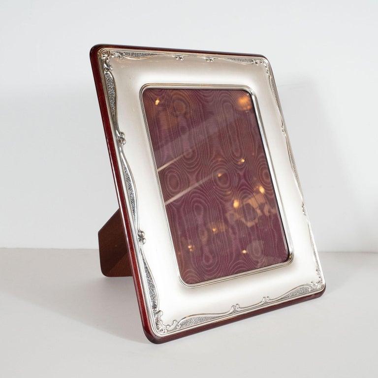 This elegant Mid-Century Modern sterling picture frame was realized by the esteemed Italian maker, Sovranti, circa 1970. It features a rectangular body with a brushed sterling silver body framed by two concentric rectangular lines on its interior