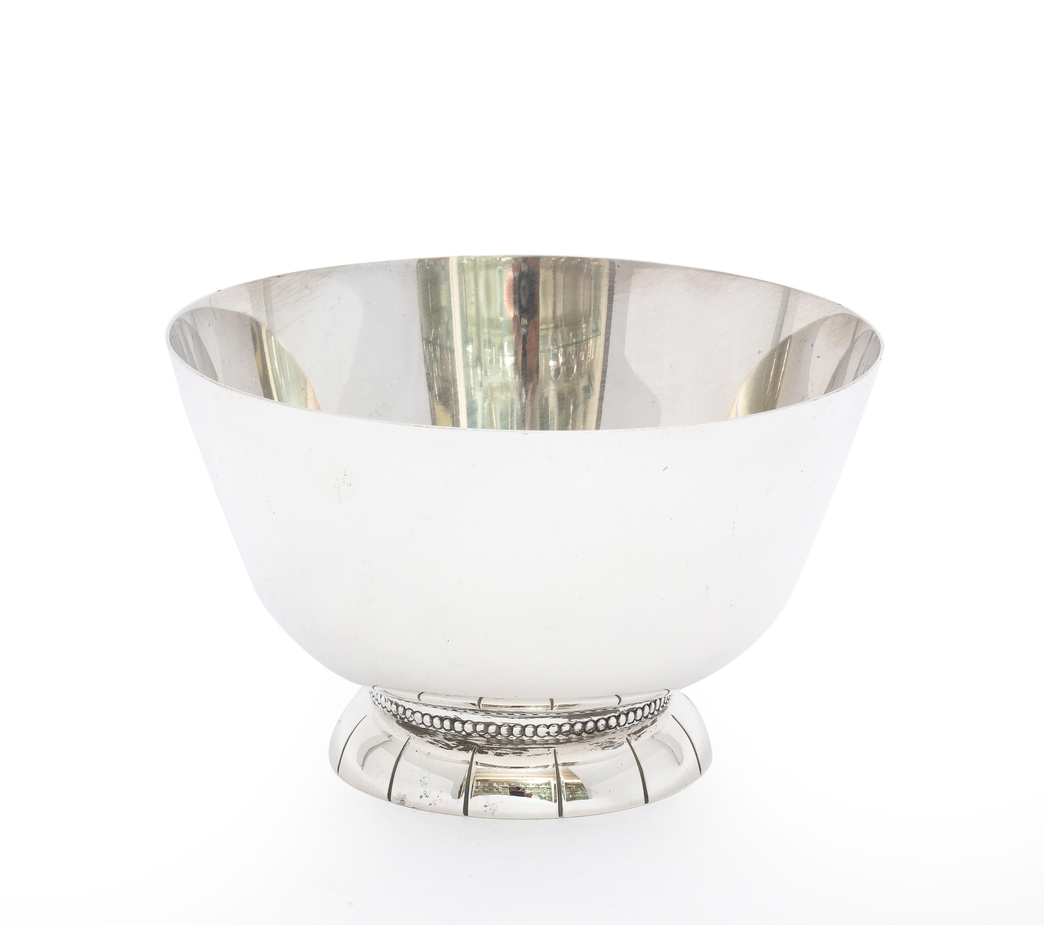 Mid-Century Modern, sterling silver serving bowl on raised base, Towle Manufacturing Co., Newburyport, Mass., Ca. 1950's. Measures 3 inches high x 5 inches diameter (at widest point); weighs 7.580 troy ounces. Dark areas in photos are reflections.