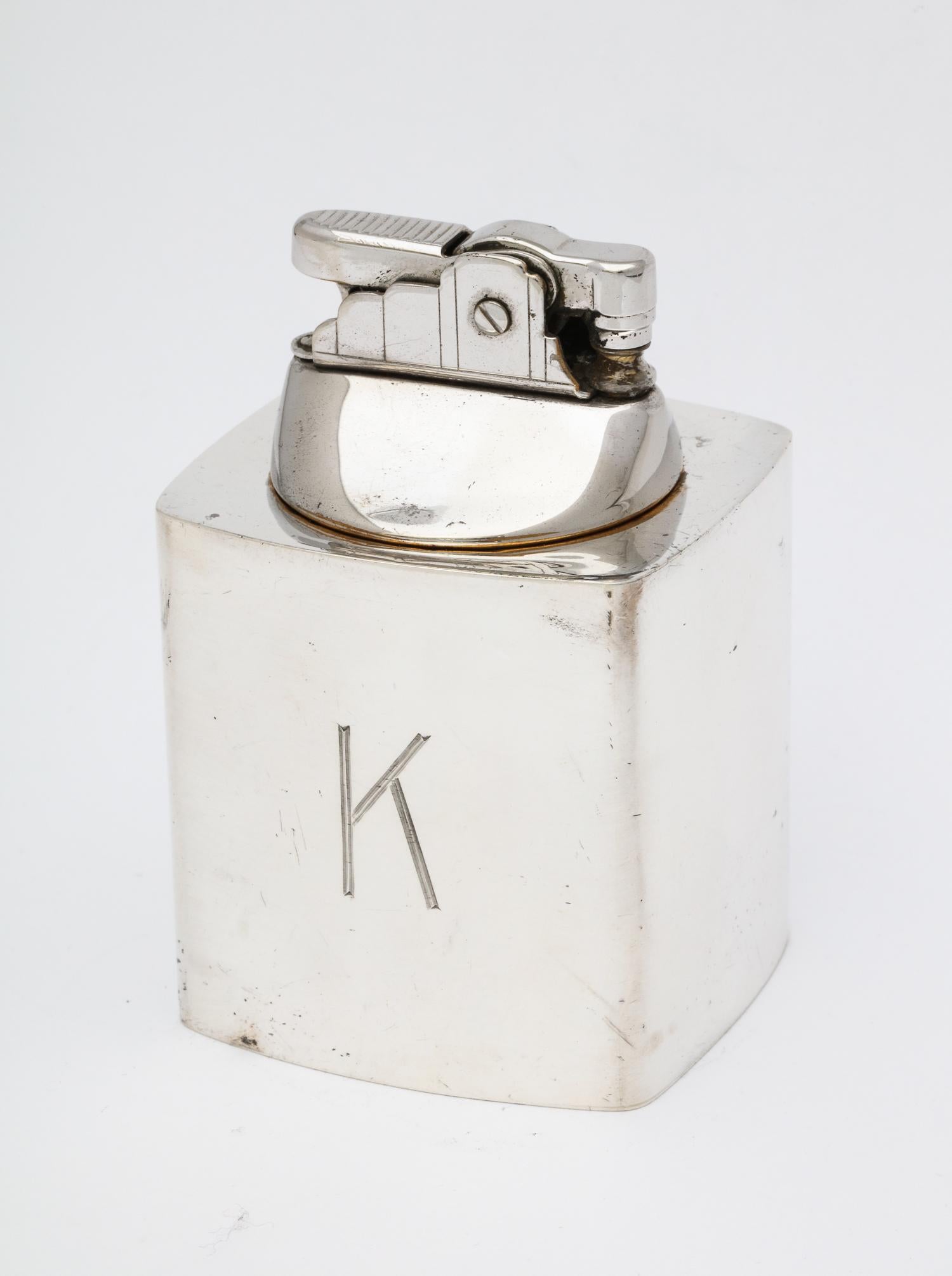 Mid-Century Modern sterling silver table lighter (workings are chrome) New York, Black, Starr and Gorham - makers., circa 1955. Monogrammed with a capital K. Measures 3 3/4 inches high x 2 1/8 inches wide x 2 1/8 inches deep. In working condition.