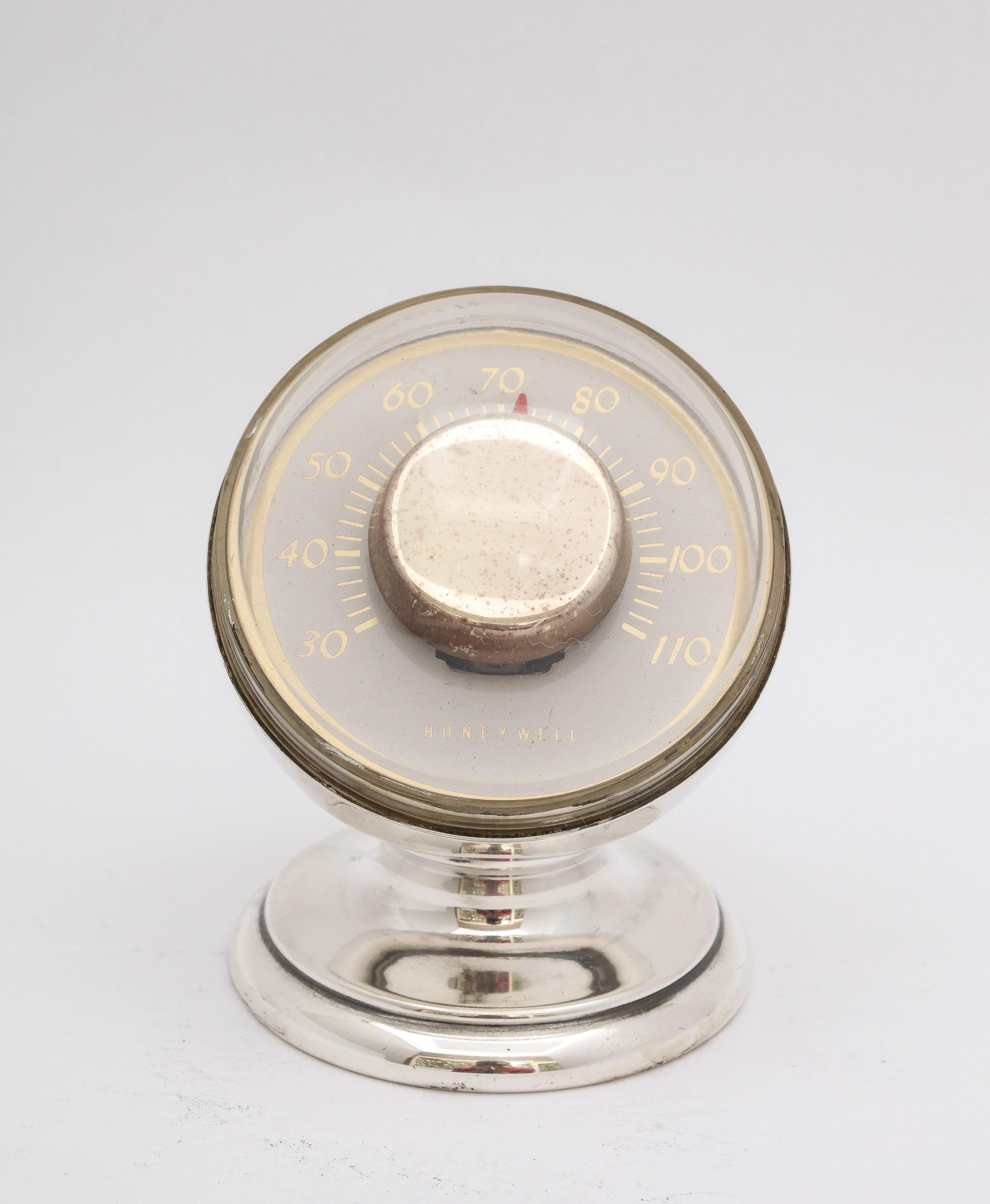 Mid-Century Modern-Period, sterling silver thermometer in working condition, Tiffany and Company, New York, circa 1950s. Works are made by the Honeywell Company. Measures 2 3/4 inches high x 2 inches diameter (at widest point - across face). Dark