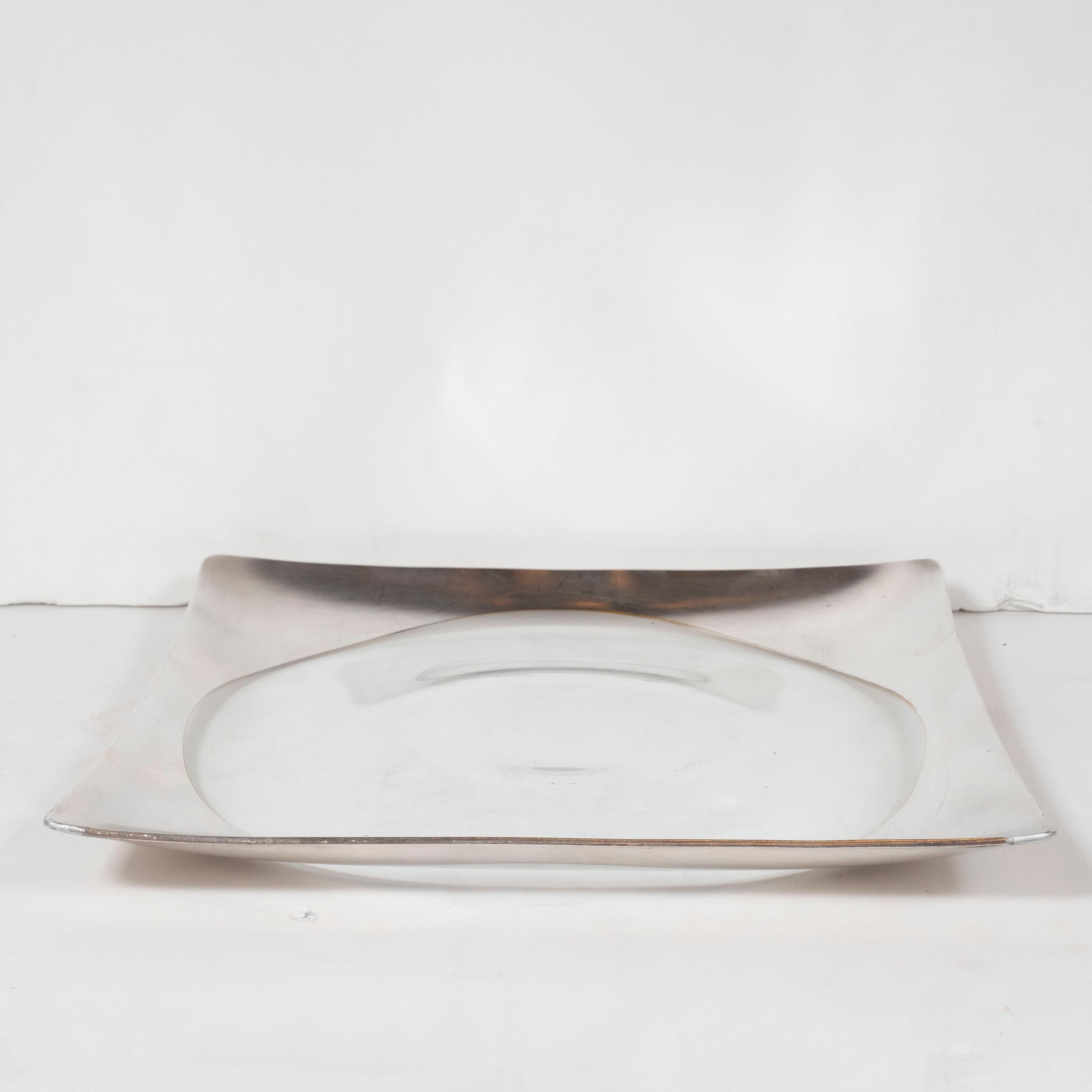 This stunning Mid-Century Modern tray was realized by the esteemed American designer Dorothy Thorpe circa 1950. It features a sterling silver inlay around the perimeter with a circular translucent glass cut out in the center. It would be perfect for