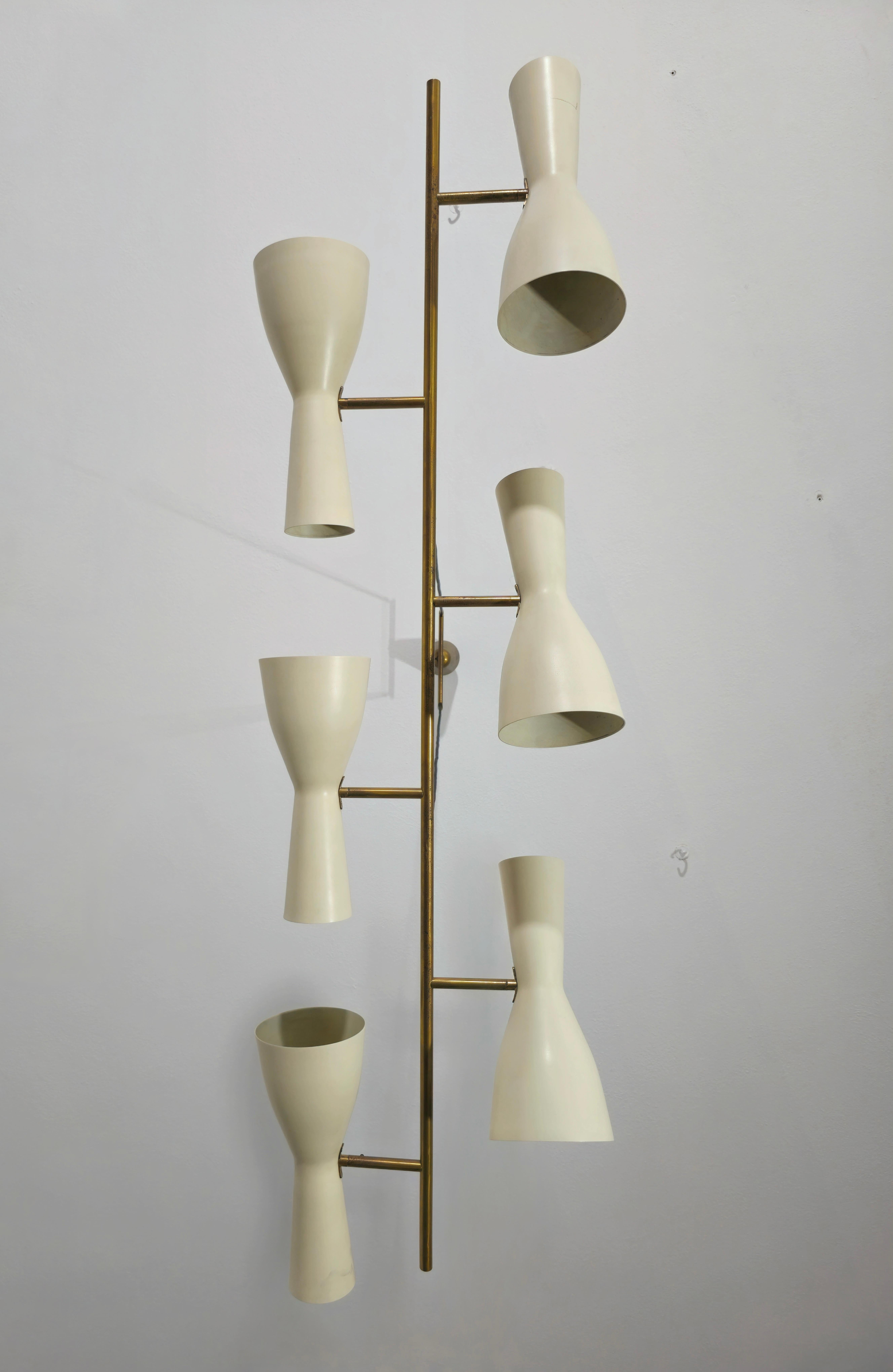 Chandelier by Stilnovo. Made in Italy, circa 1950s. Six double light diffusers run in a sequential pattern along a linear brass suspension rod. The diffusers are painted in a white tone color. The diffusers can rotate slightly in various positions