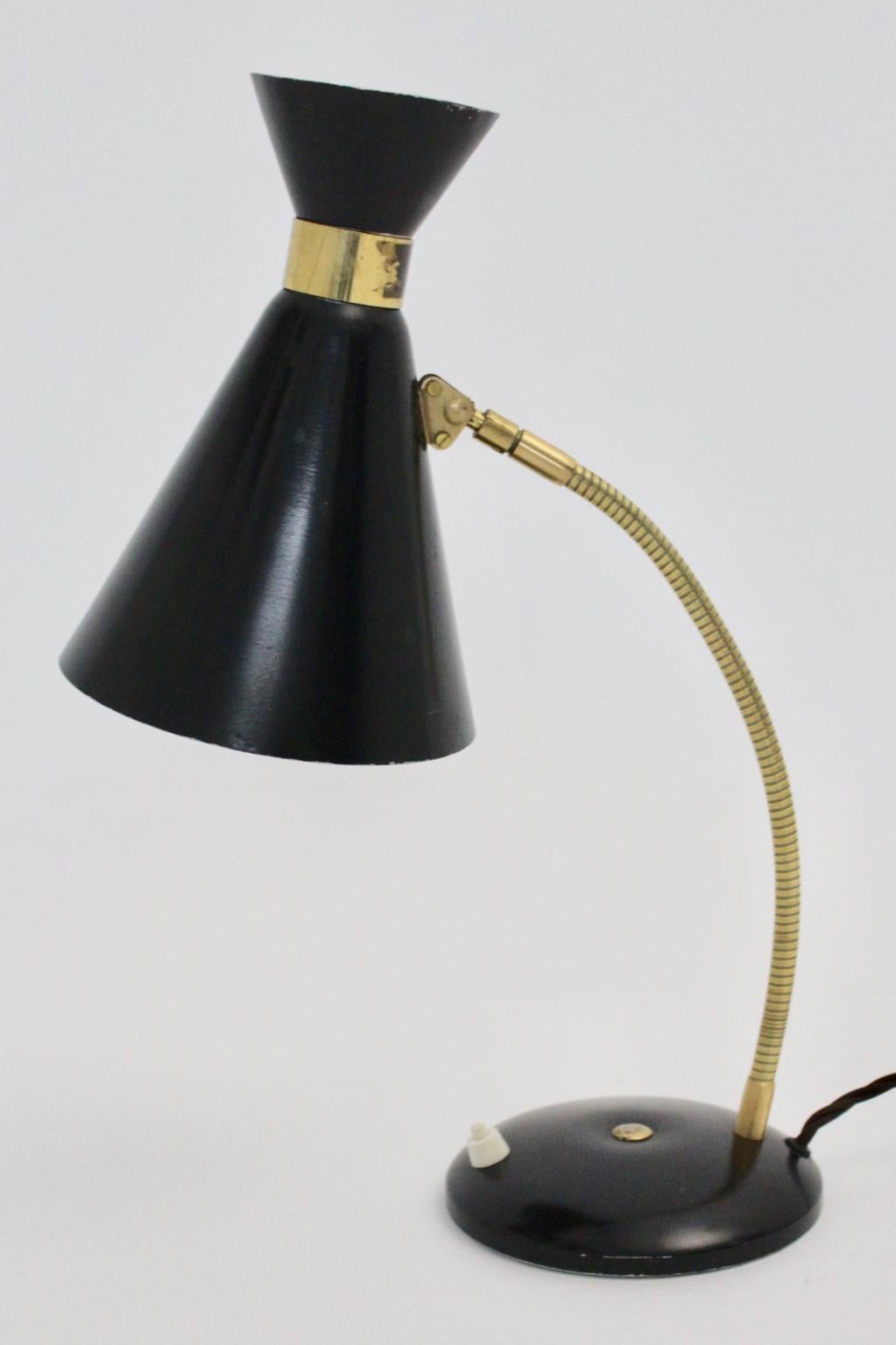 We present a charming brass and black table lamp by Stilnovo Italy 1950s.
The table lamp was made of black lacquered aluminum and a flexible stem with brass details. With the brass flexible stem the table lamp is easy to switch in each