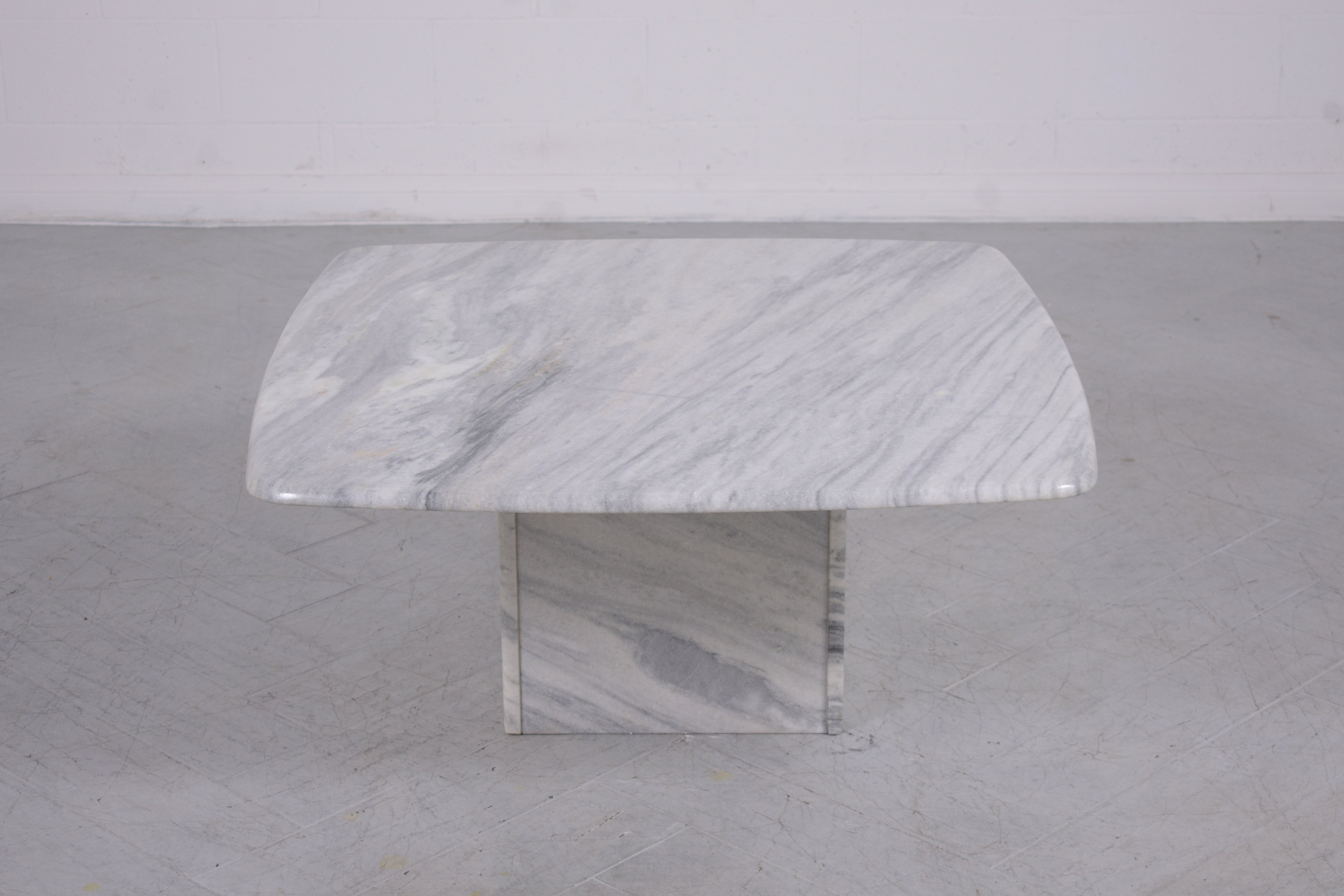 Step into the elegance of the 1980s with our mid-century modern marble coffee table, a vintage piece that seamlessly combines timeless aesthetics with contemporary design. Hand-crafted with the utmost attention to detail, this table is a standout