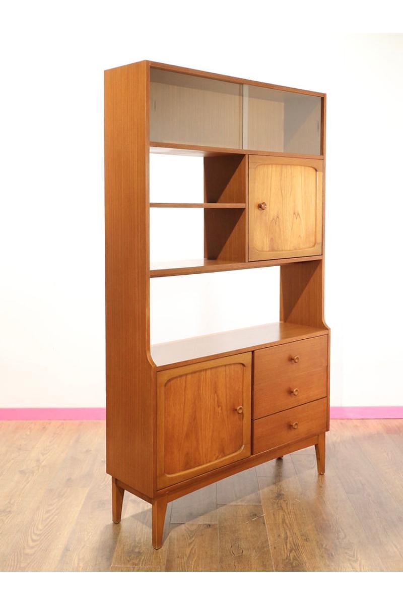 Step into timeless elegance with the Mid Century Modern Stonehill Stateroom Teak Room Divider Display Drinks Bookcase from Mid Century Traders. This retro cabinet by Stonehill for their stateroom range is a great way to store books, show off pottery