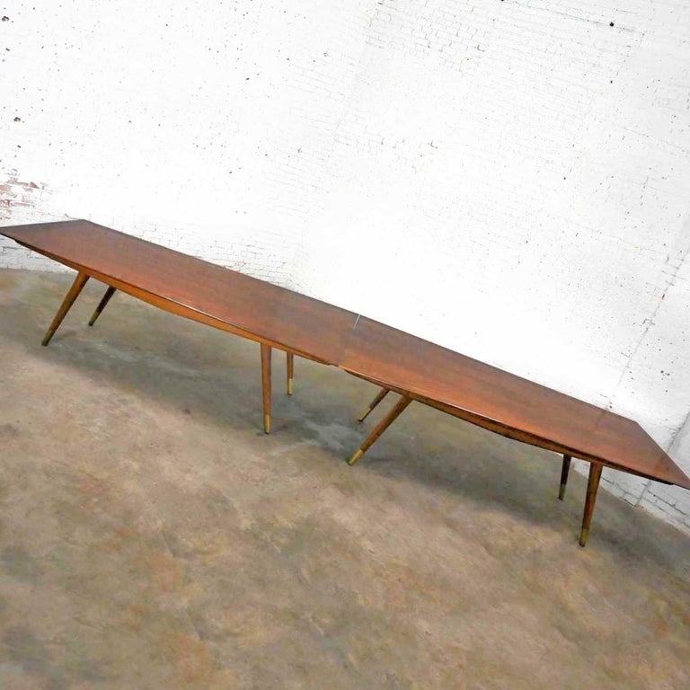 Fabulous Mid-Century Modern Stow & Davis 2-piece conference table designed by Giacomo Buzzita. It is comprised of a solid walnut perimeter with a veneer inner surface tabletop, back-beveled edges and eight tapered walnut legs with brass sabots.