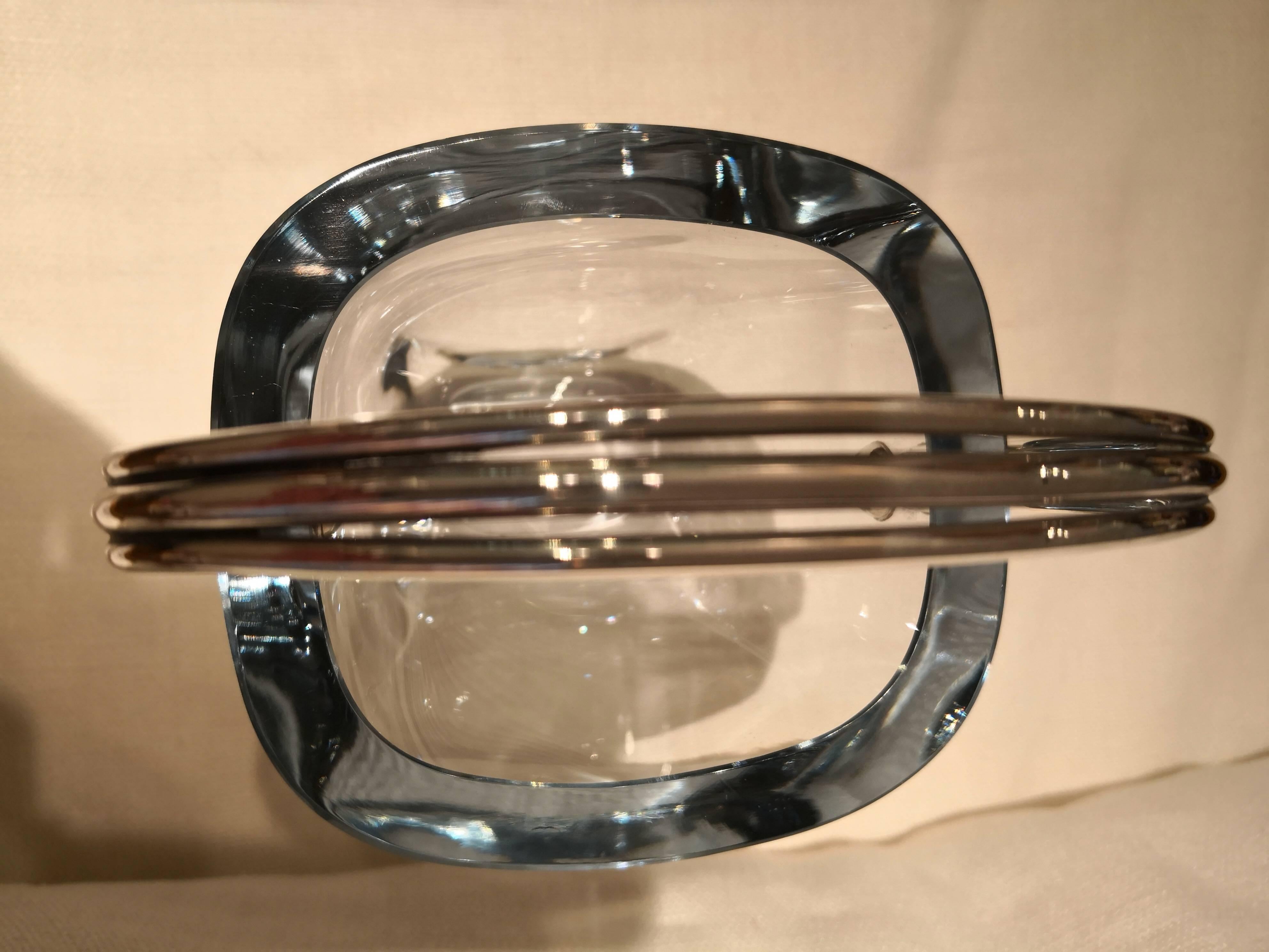 Clean modernist ice bucket in translucent glass with 925 silver handle. In the bottom signed Stromberg. Stromberg was founded in Sweden by the Stromberg family in 1876 and 1976 sold to Orrefors in Sweden. The glass is about 1.5 cm thick and gets a
