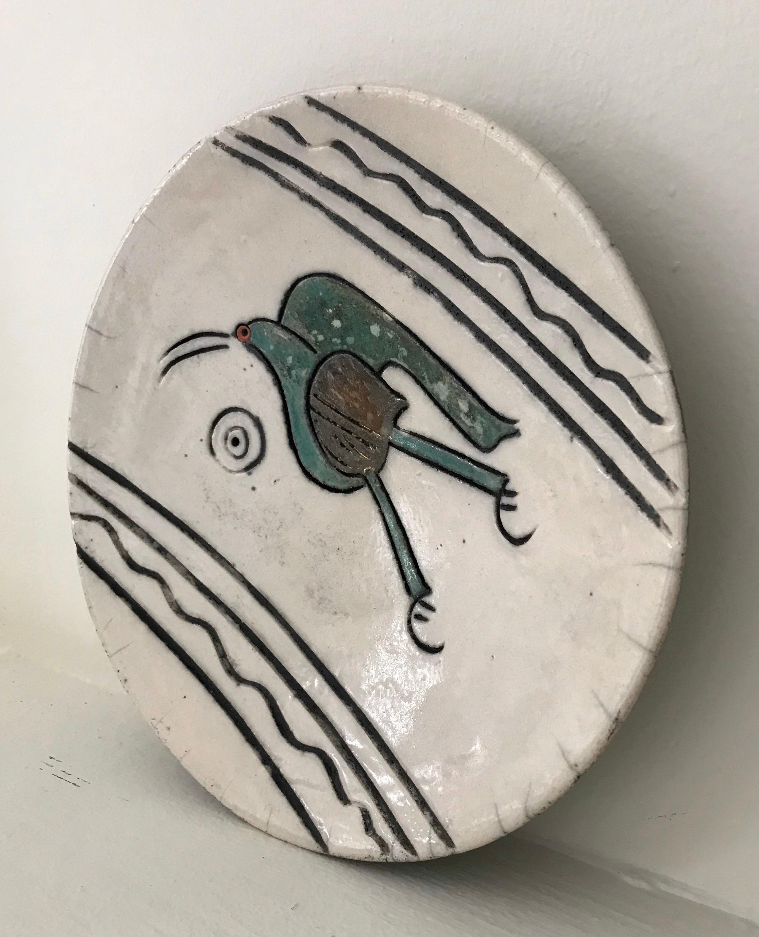 Nice metallic glazed midcentury ceramic dish depicting a Dodo bird, signed by the artist, wired for hanging.