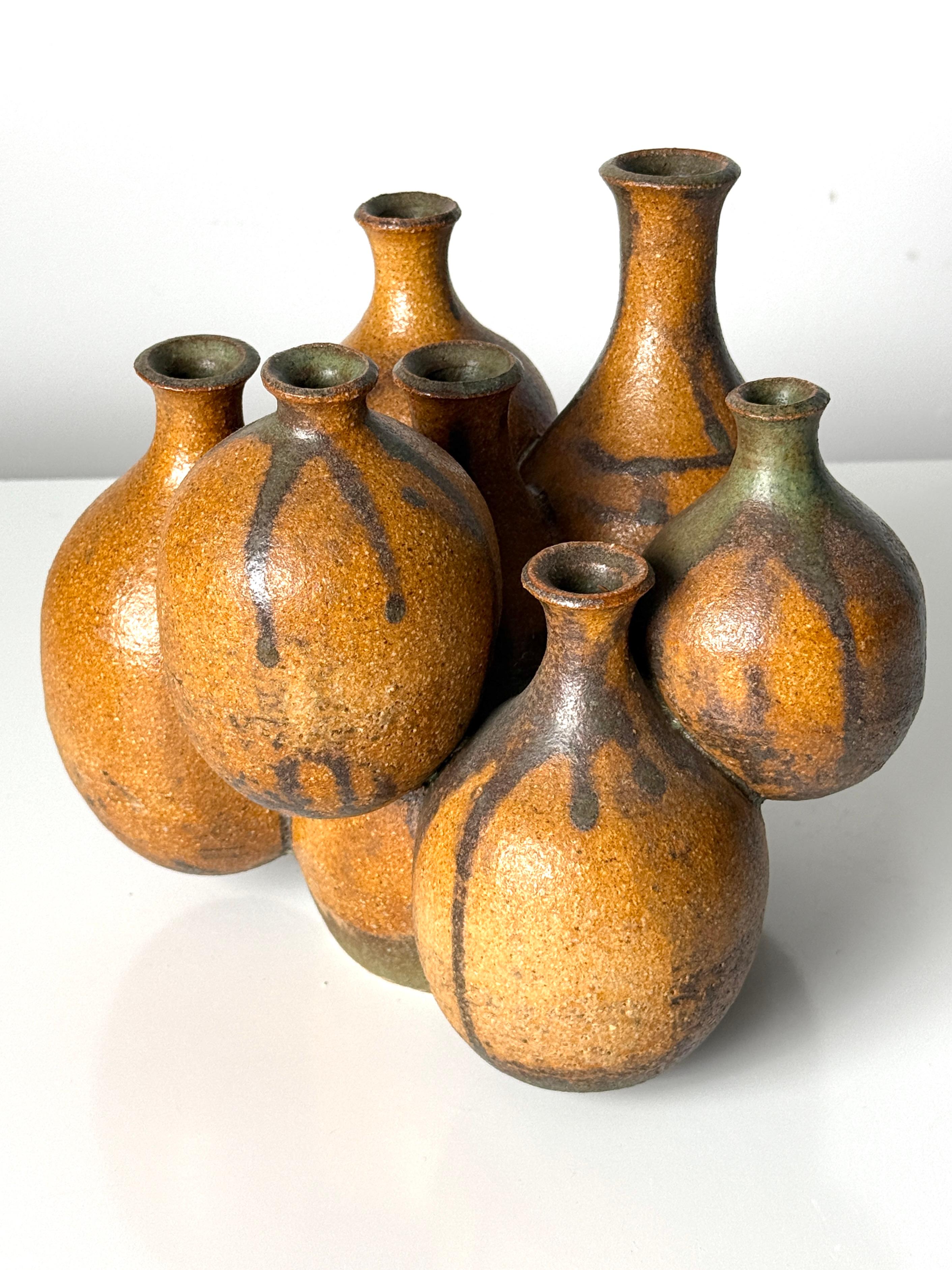 Impressive large sculptural ikebana weed pot cluster circa 1970s

Seven conjoined vessels of varied form and elevation
Executed in stoneware with natural earth tone glazes
Signed by the artist

9 inch width
7.5 inch depth 
8 inch height