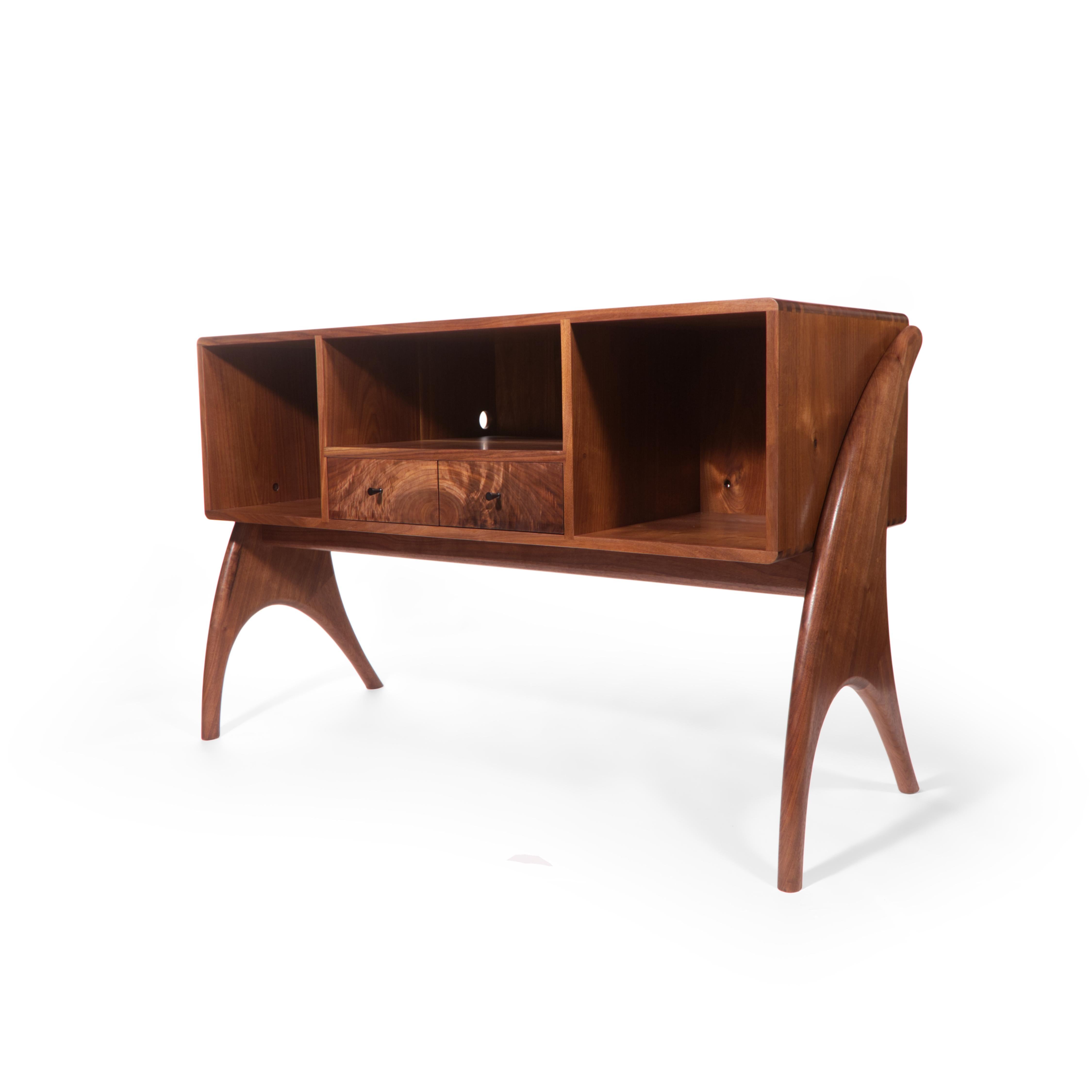 Designed and crafted at our Chicago studio, the HiFi Record Cabinet is a must-have home for your prized audio equipment. Crafted from solid Walnut wood and featuring hand-cut dovetail construction with hand-turned Ebony wood pulls, this case piece