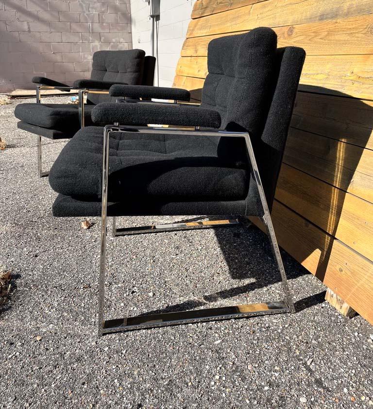 These mid-century style chairs shine with chrome legs and arms and black fabric that is in great shape. A beautiful addition to any mid-century, modernist, or eclectic style of design.