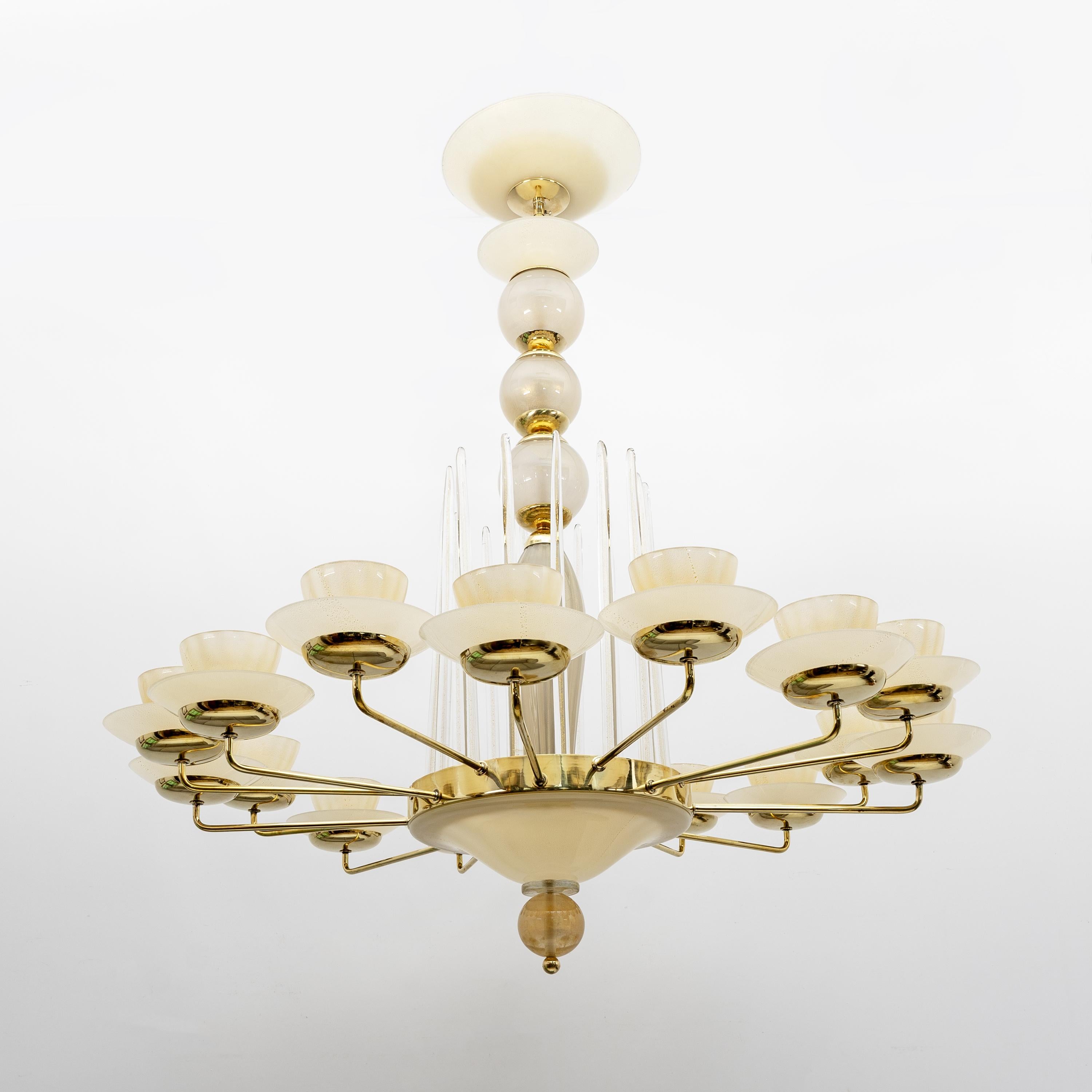 Elegant Murano glass chandelier with a luxurious vintage design. This light features 16 arms, the frame is made of brass and blown glass with gold leaf, translucent glass. The central frame is composed of a series of overlapping bulbous shapes that