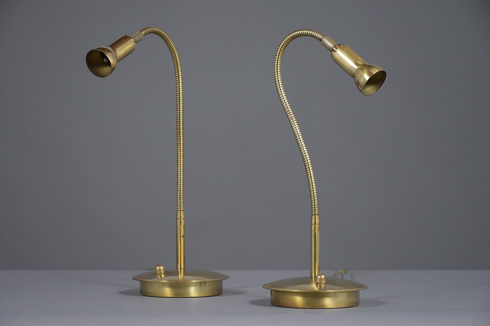 A beautiful pair of Mid-Century Modern table lamps crafted out of brass and are in great condition. These reading lamps feature an adjustable neck and have been newly cleaned and polished. These lamps are wired to US standards, in working condition,