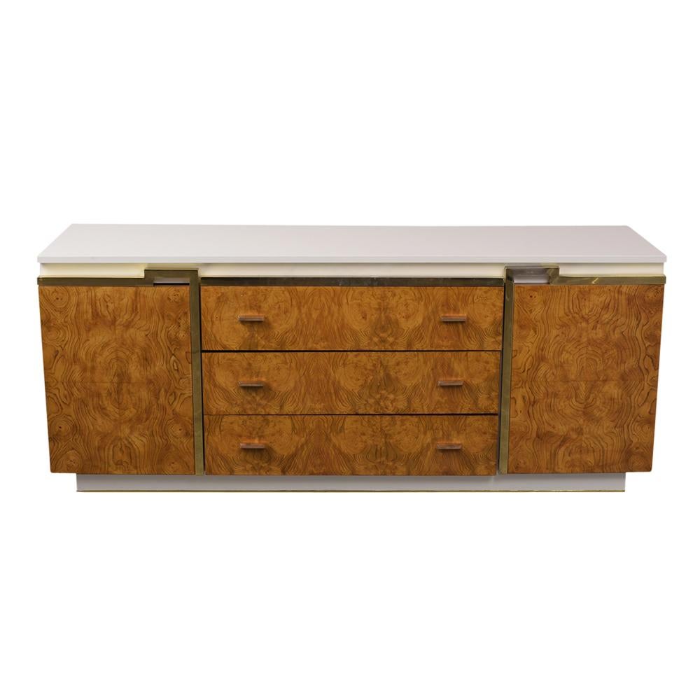 This 1970s Mid-Century Modern Burled Chest of Drawers has been professionally restored and has been newly refinished in walnut & white color combination with a lacquered finish. The sleek credenza features three large center drawers with chrome