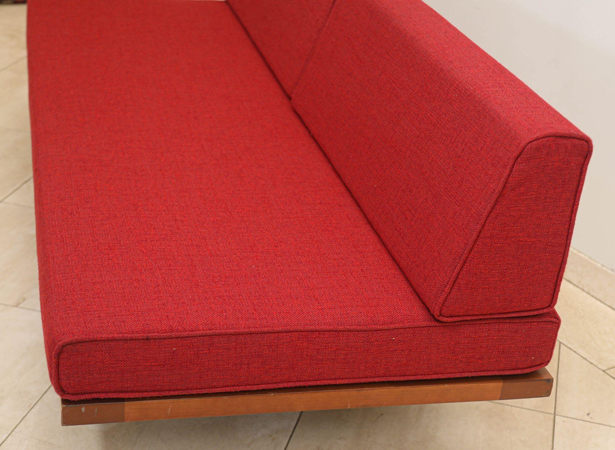 This is a Nelson style classic daybed with red fabric.
Mid century modern in the style of George Nelson for Herman Miller daybed, sofa lounge featuring iron hairpin legs with pine back support and upholstered cushions.
Timeless, modern classic