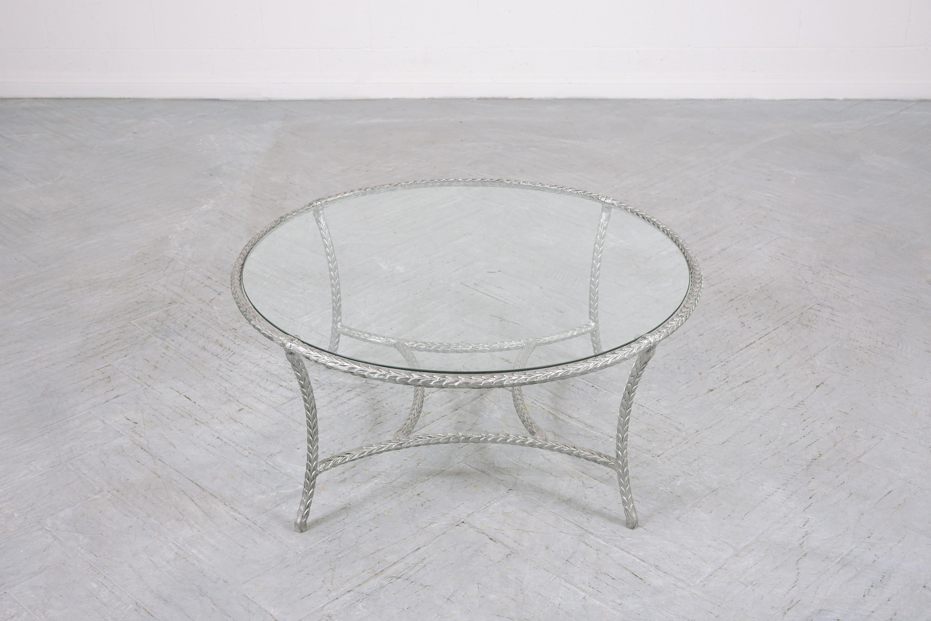 This extraordinary vintage mid-century modern round glass coffee table is in good condition, is hand-crafted out of a metal and glass combination, and has been completely restored by our team of expert craftsmen. This fabulous vintage coffee table