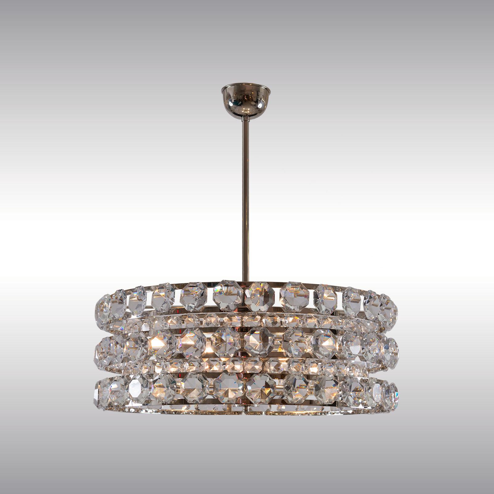 Very solid and heavy crystal chandelier from the 1960s. In three rows each with 26 very large, handcut glass prisms are arranged. 4 x E14/12 60 W
Most components according to the UL regulations, with an additional charge we will UL-list and label