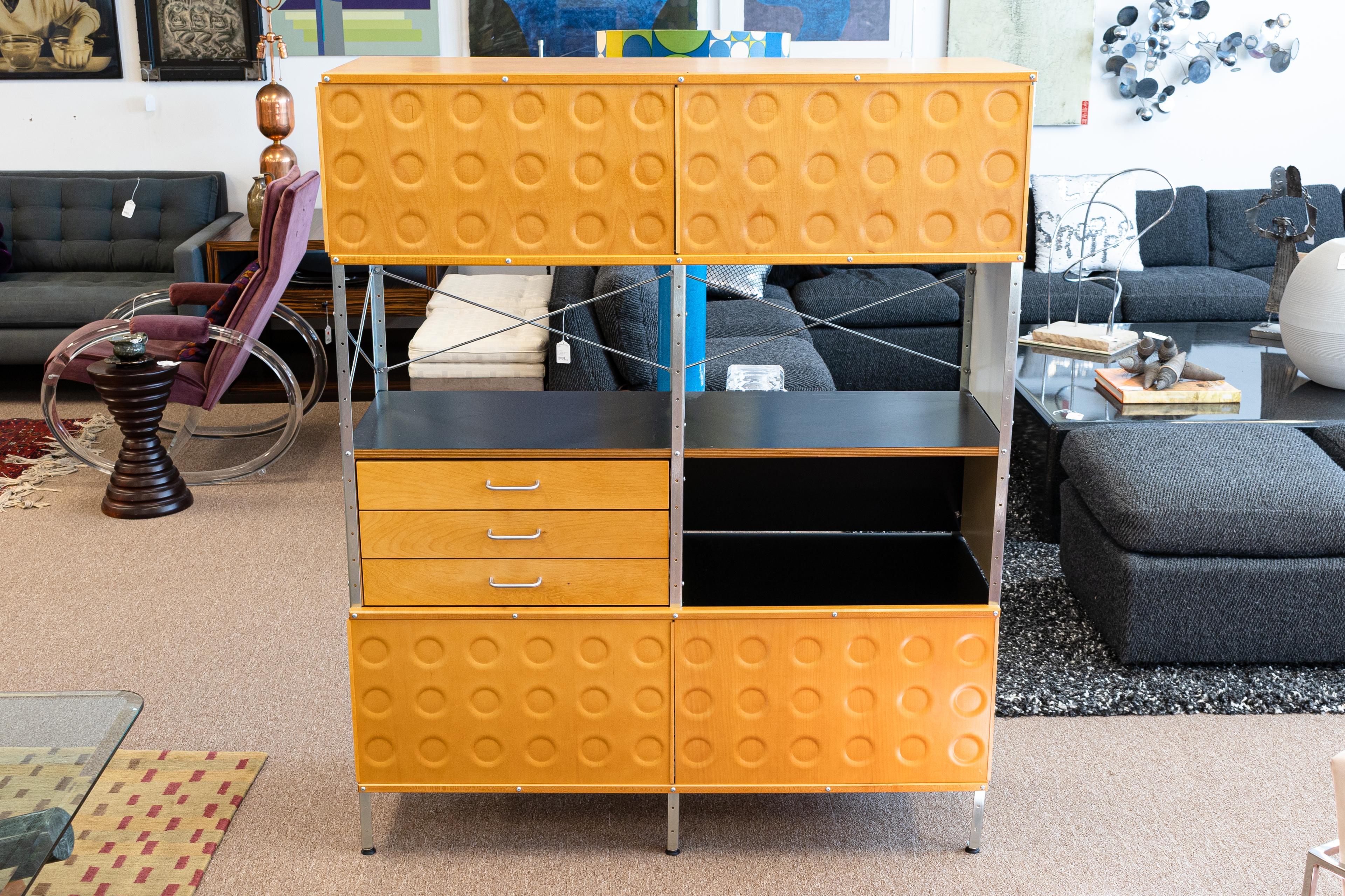 An iconic mid century modern piece, the Design Within Reach Eames Wall Unit. This wonderful wall unit is in very good vintage condition with just one damaged cupboard sliding door, pictured above. This piece features a wonderful, colorful design,