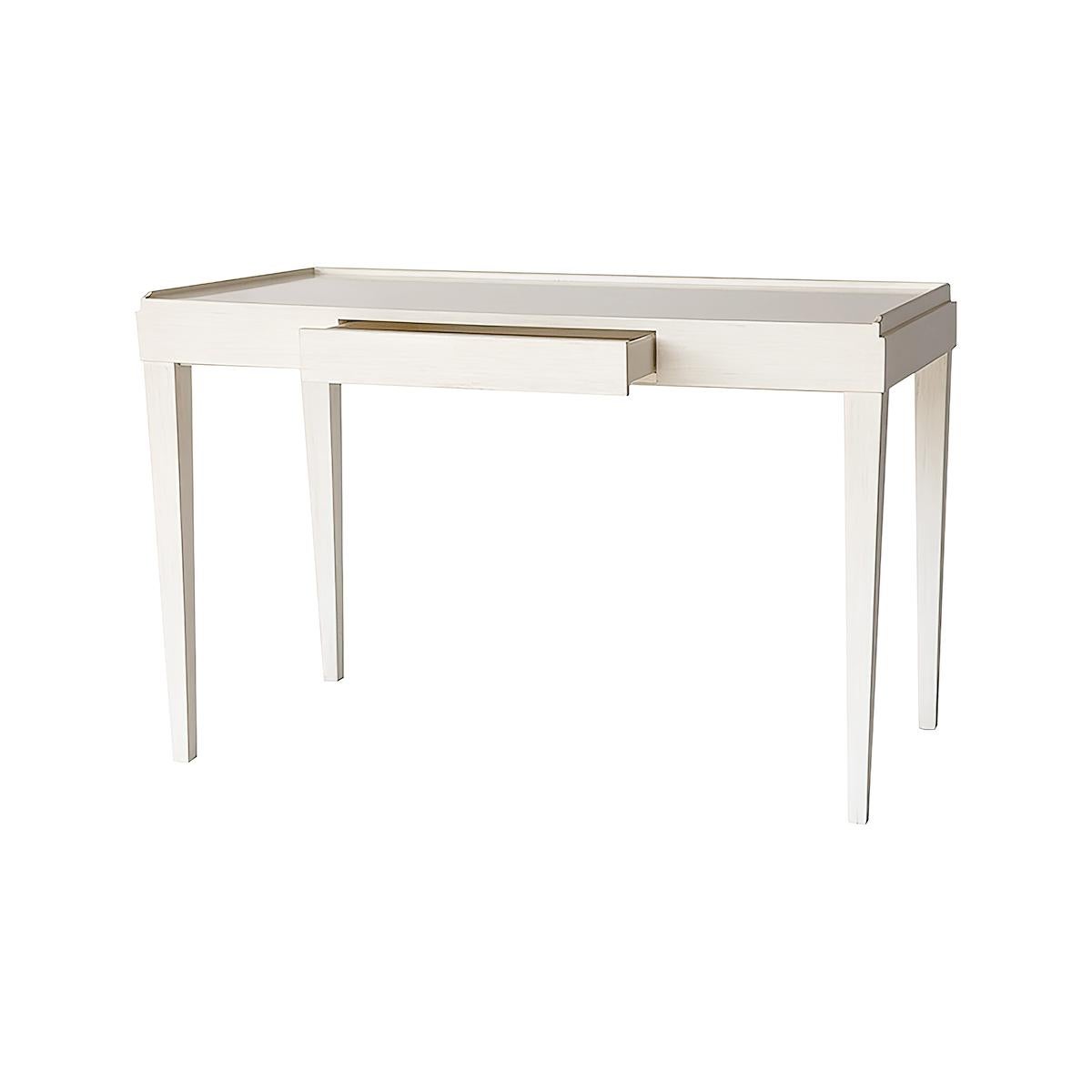 Mid-Century Modern style desk with a three-quarter wooden gallery, a single frieze drawer, and raised on square tapered legs. Finished in our custom drift white lacquer.

Dimensions: 48