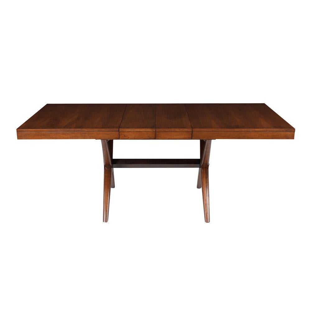 This Vintage Mid-Century Modern Dining Table is made out of walnut wood stained in walnut & black color combination and newly lacquered finish. This writing table features an extendable top with two leave and rests on an X design stretched pedestal