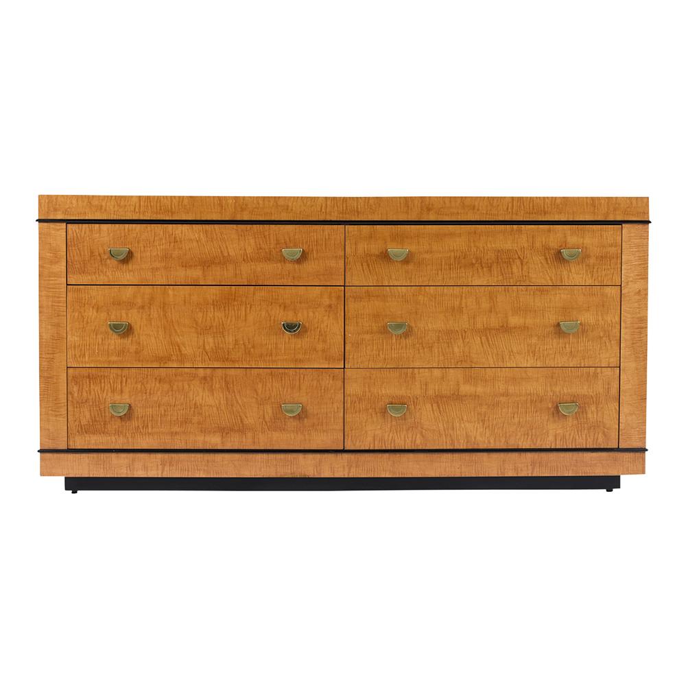 This Mid-Century Modern faux birch dresser has been professionally restored, finish in maple, and black color combination with a lacquered finish. This chest of drawers features a total of six large drawers and each comes with two solid brass