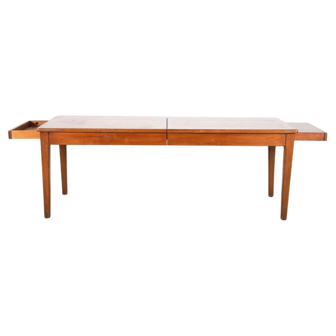 John Stuart oak modern version harvest farm table style 4 plank detail with edge detail on 4  square tapered legs. Has (1) silverware drawer at one end and a pull out server on the other . Good vintage condition very solid dining table. Labeled John