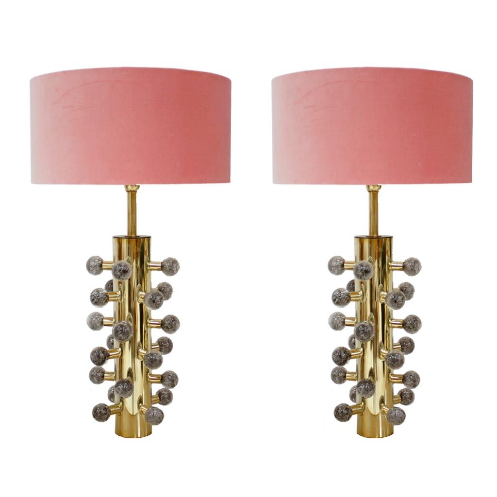 Pair of sculptural Italian table lamps with cylindrical structure made of polished brass and grey Murano glass spheres.
Circular lampshades made of pink cotton velvet fabric.
 