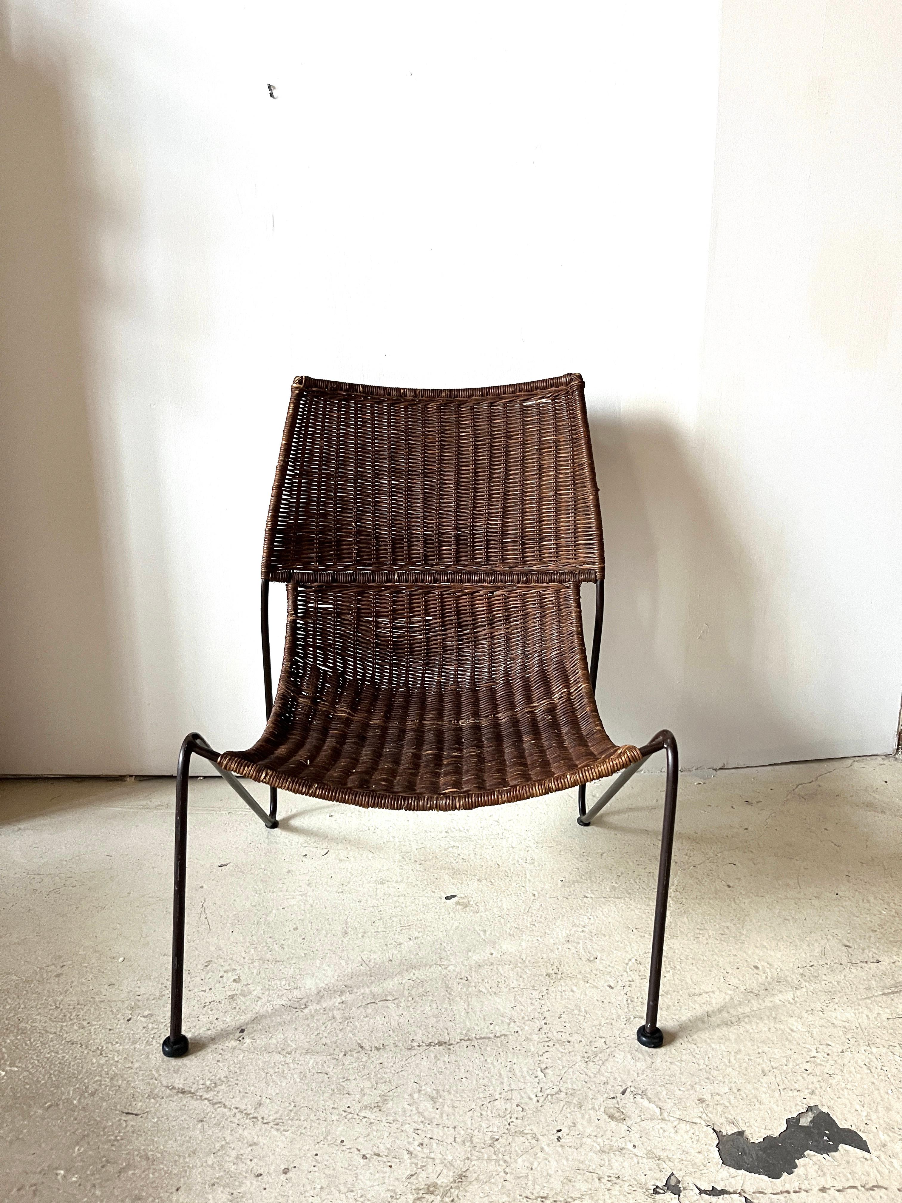 Classic MCM-style wicker lounge chair in a design by Frederic Weinberg. Great lines and very versatile for indoors or outdoors. 

While the original of this chair was released in the 1950s, this is more than likely a version released by Pier One in