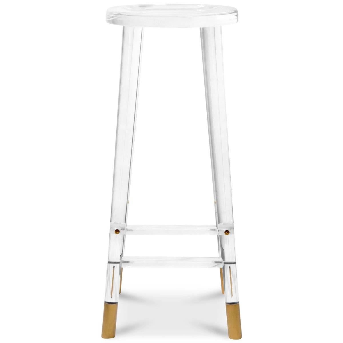 The Helsinki Bar Stool is an unassuming beauty. Featuring a solid lucite body and brass capped legs, the Helsinki Bar Stool is a stylish new take on the classic barstool. Its clear body reflects its surroundings and changes with the light of the