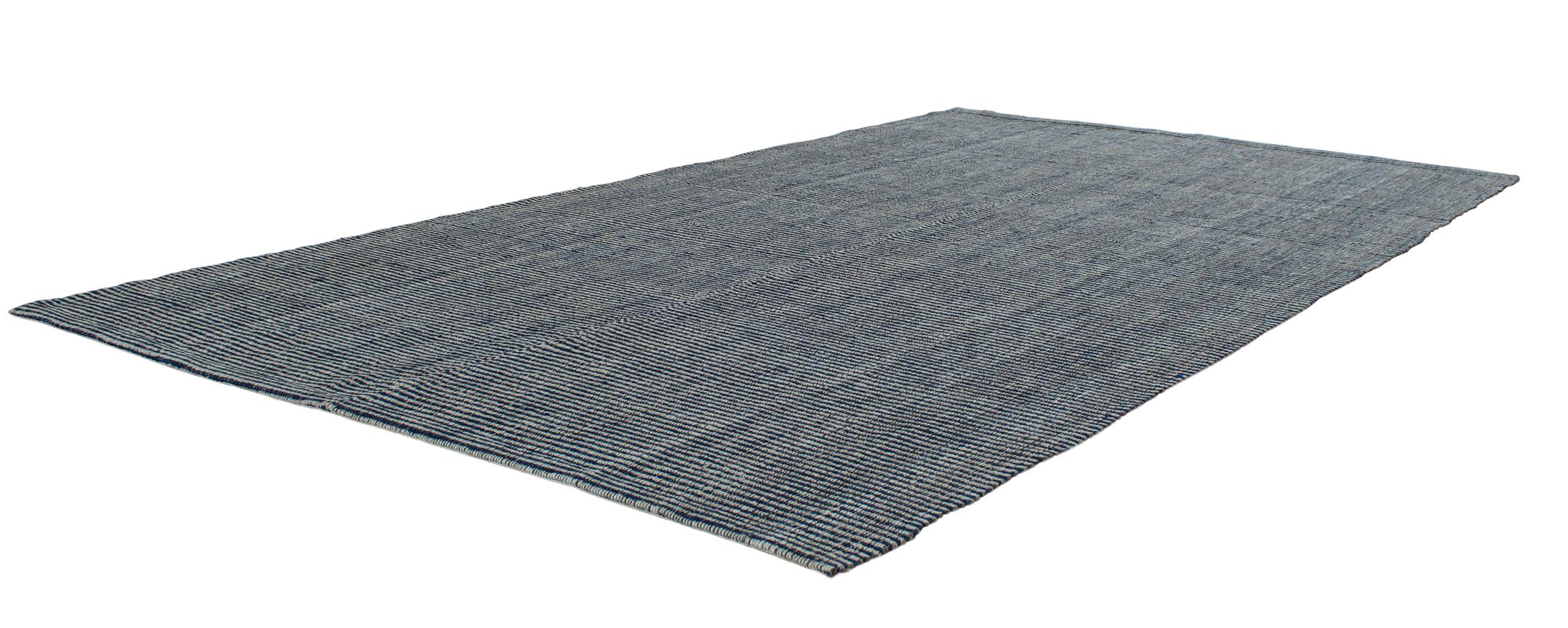 This Pelas flat-weave rug is made with handspun wool and natural dyes. It is inspired by the antique kilims that are native to the Kurdish region in Iran. NASIRI continues their rich tradition of rug making by applying the same techniques and