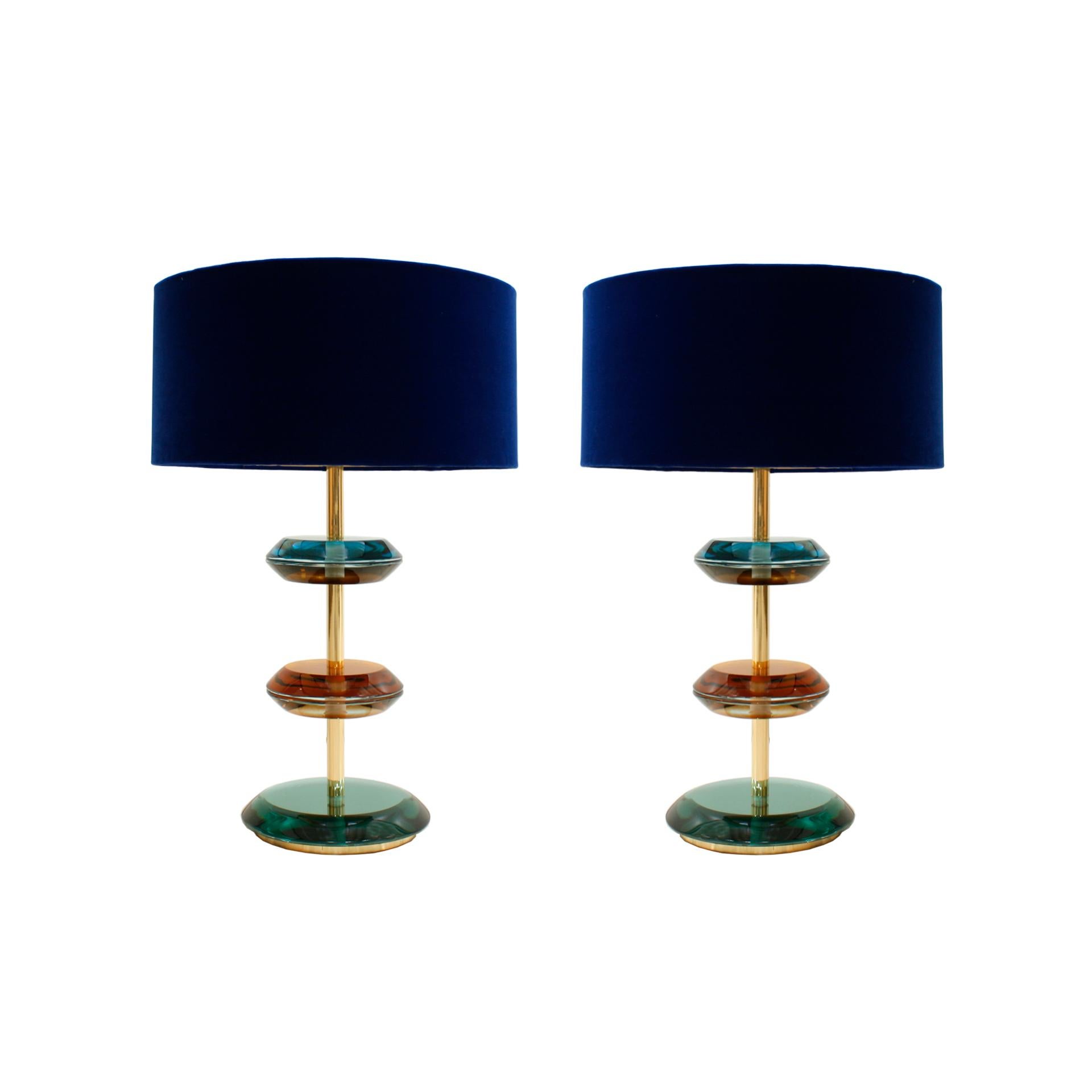 Pair of table lamps designed by L.A. Studio. Structure made of solid brass with Murano colored glass pieces.
Manufactured in Italy. Circular white bouclé wool lampshades.

Dimensions with lampshades: Diameter 55 x height 70 cm
Dimensions of the