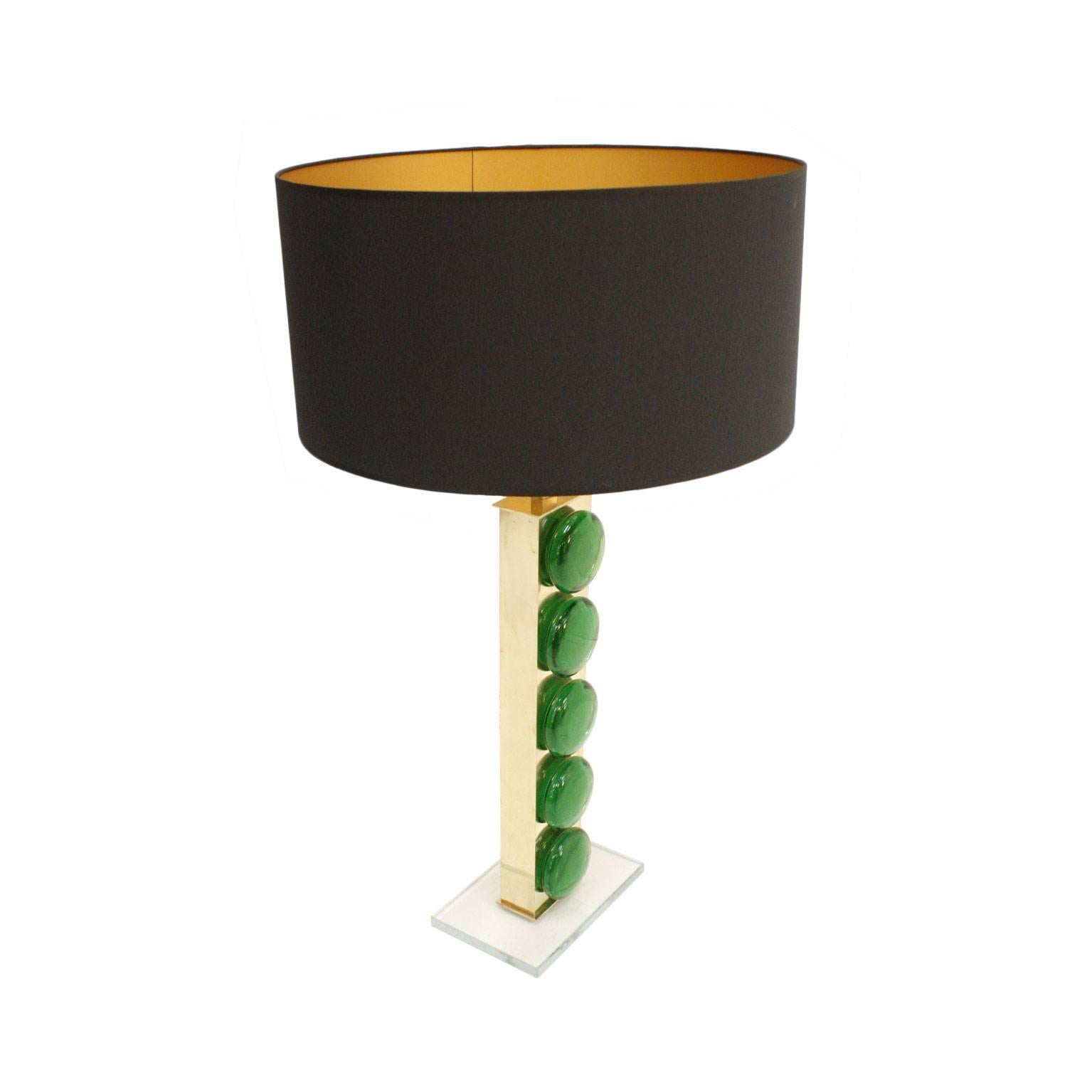 Midcentury style pair of Italian table lamps with brass structure and green murano glass pieces. Circular screens in black velvet.

This mid-century modern style table lamp showcases a beautiful blend of elegance and retro charm. Its brass structure