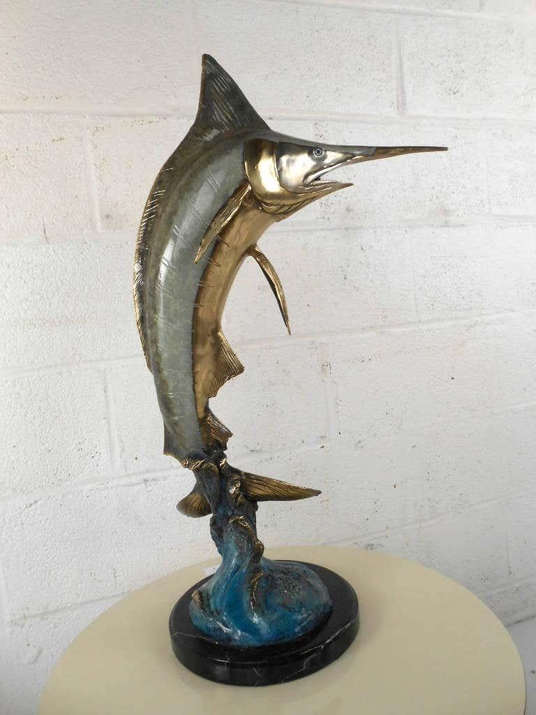 This tabletop Marlin features a wonderful mixture of colors and finishes, and a fantastic attention to details. This heavy bronze statue is a perfect addition to any room in need of an elegant nautical enhancement. Please confirm item location (NY