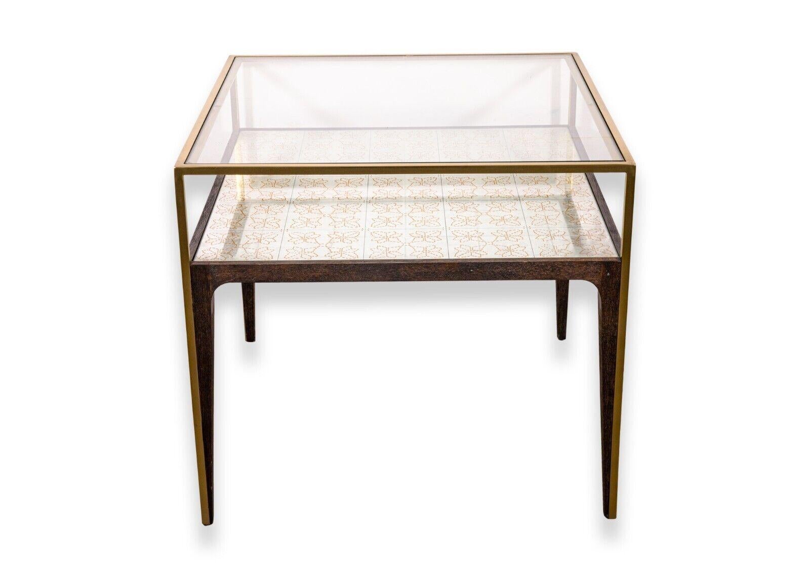 A pair of Arhaus square glass, wood, and brass, side end tables. A wonderful set of end tables featuring a lovely orange floral design, a great choice of materials, and a removable glass top. These tables are in very good condition. Each of these