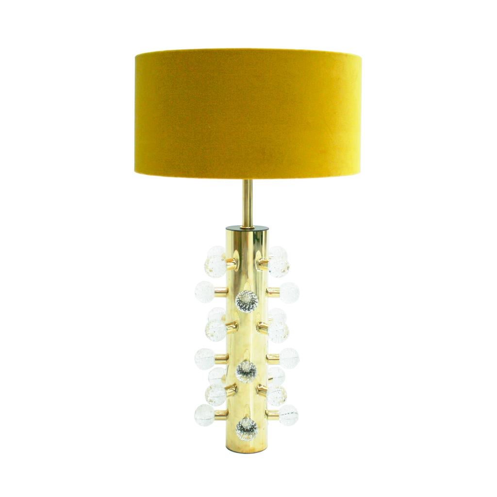 Contemporary maximalist pair of brass table lamps, a stunning blend of modern design and opulence. This exquisite lamp features a cylindrical Polished brass structure adorned with spherical Murano clear glass pieces, adding a touch of vibrancy and