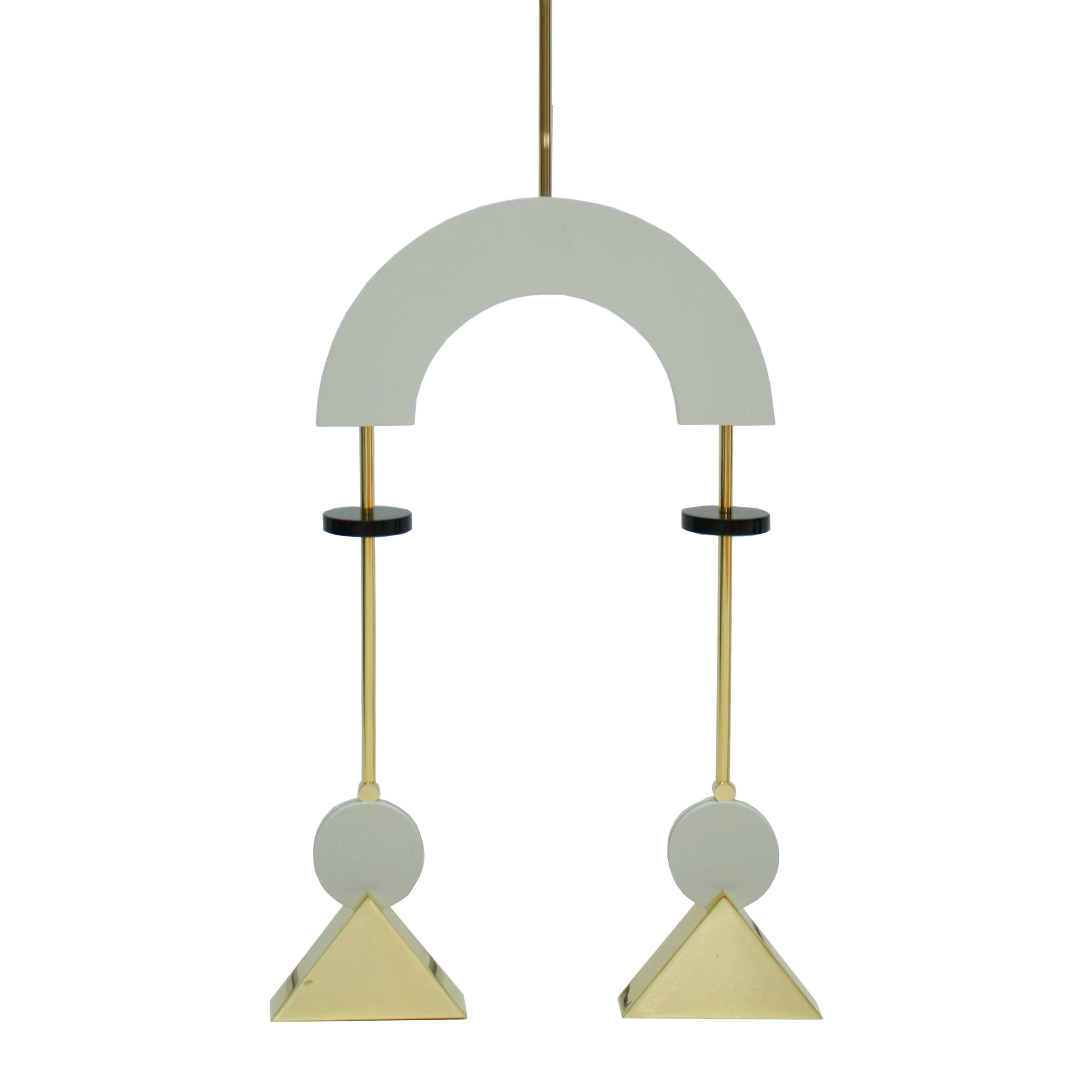 Pendant lamps composed of two points of light. Made of gold-plated bronze structure with white and black lacquered wood pieces. The design of this item was inspired by the radical geometry of constructivist art. The pendant lamp is constructed from