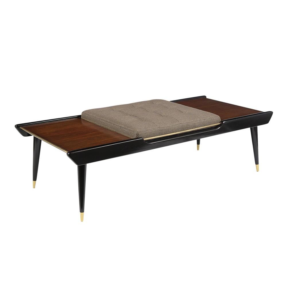 This Mid-Century Modern low bench has been completed restored and is made out of mahogany and rosewood combination with a mahogany/black lacquered finish. This bench features a single center seat that has been newly upholstered in a beige pattern