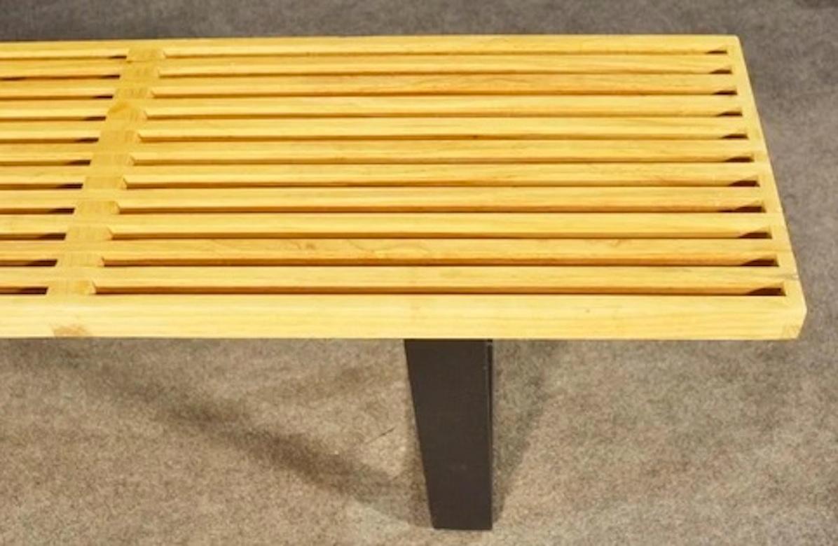 Modern slat bench in the style of George Nelson featuring a maple finished top with a sturdy black base.

Please confirm item location (NY or NJ).