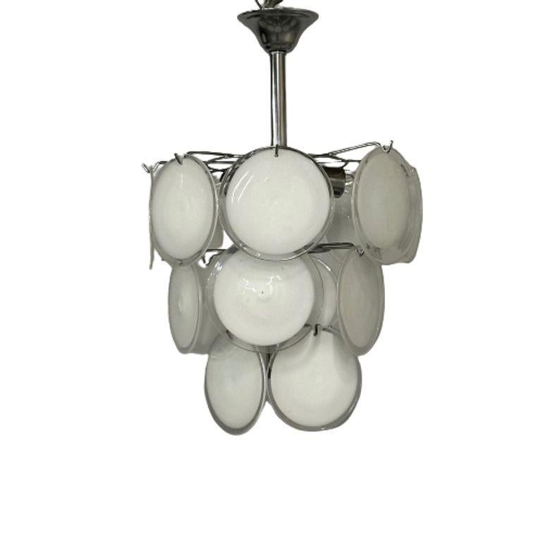 Pair of Mid-Century Modern Style Small White Murano Glass Disk Chandeliers / Pendants

A pair of mid-century modern Murano glass chandeliers in a classic suspended disks configuration. Each fixture has 18 pale, translucent glass over white Murano