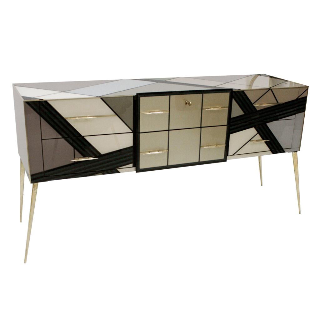 Italian sideboard made of solid wood structure from the 1950s and covered in Murano colored glass. Composed of six drawers with brass handles and legs.

Our main target is customer satisfaction, so we include in the price for this item professional