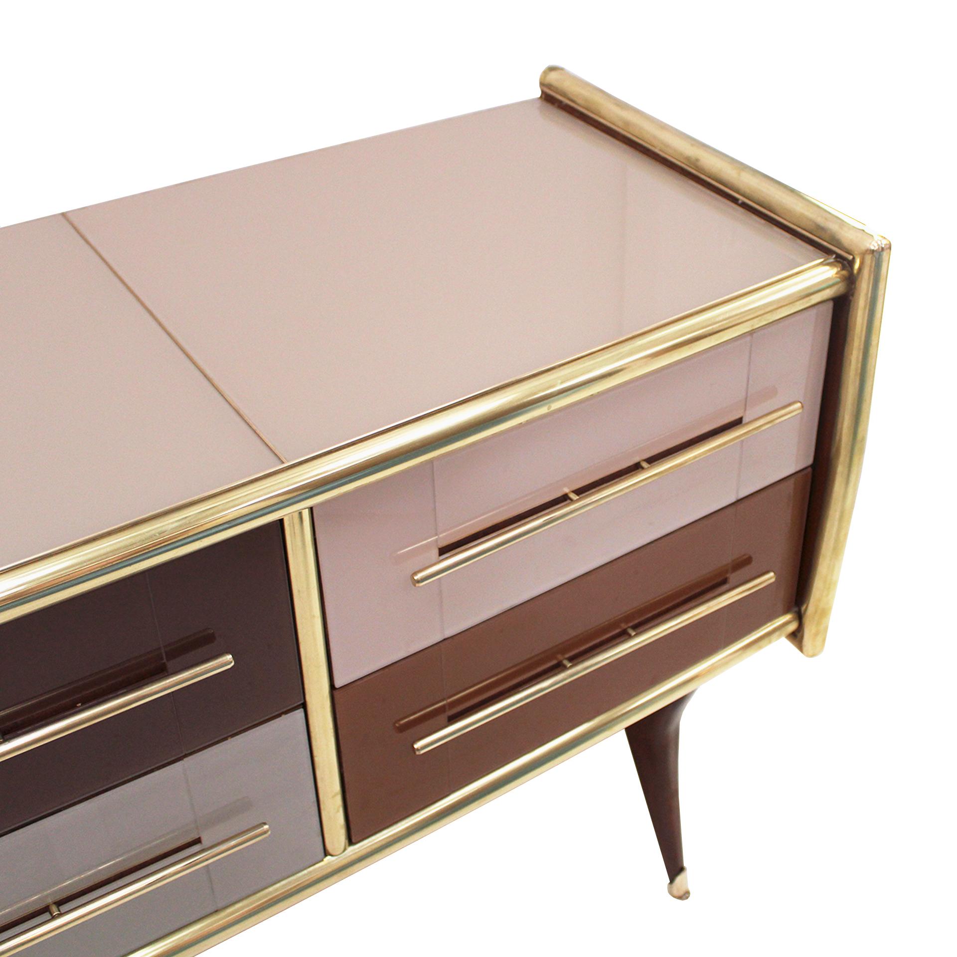 Sideborad comoposed of 6 drawers with original 1950s solid wood structure covered in colored glass. Handles, profiles and legs made of brass. Italy.

Our main target is customer satisfaction, so we include in the price for this item professional and