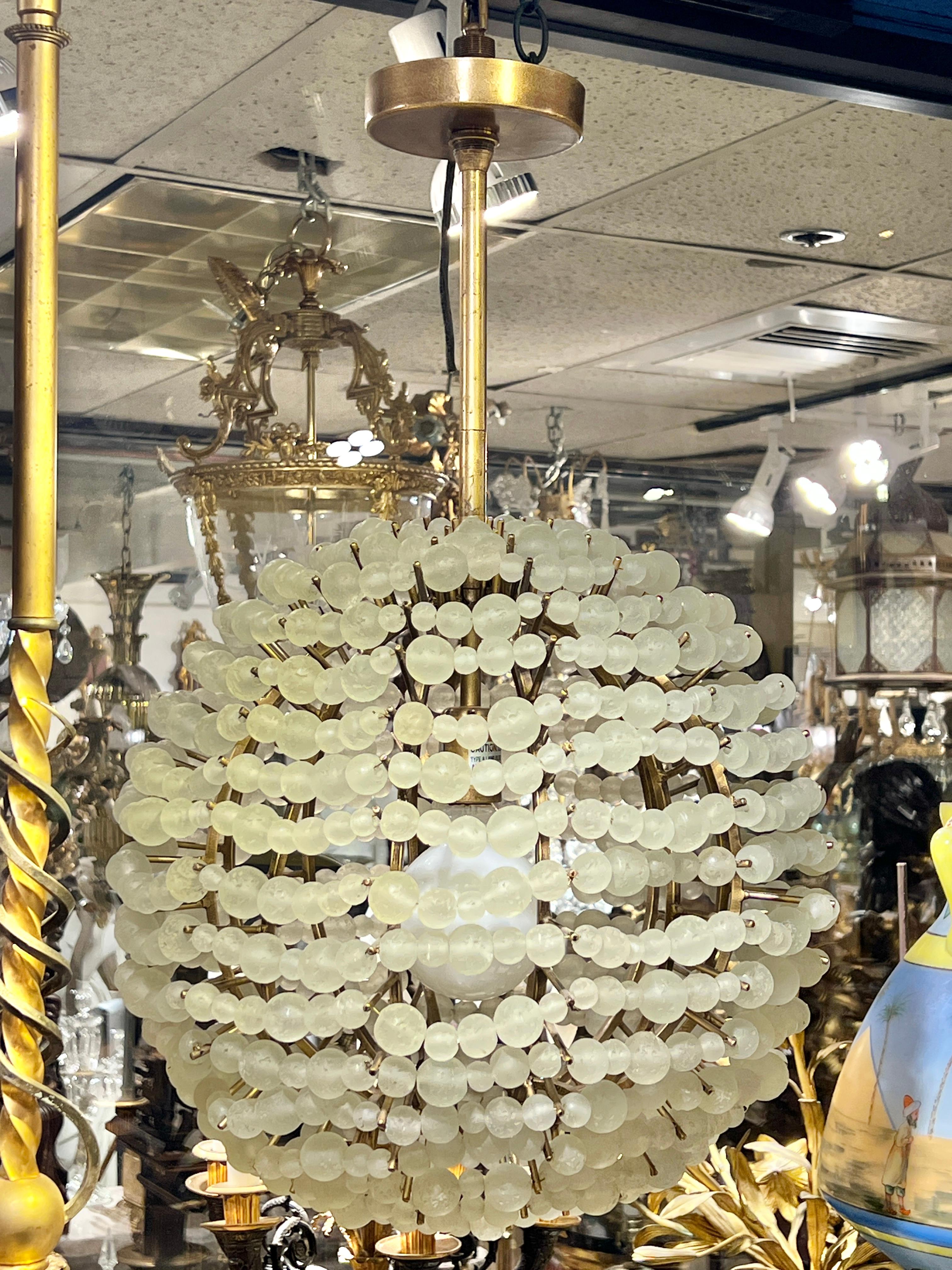 Spherical chandelier with brass frame and over 720 glass beads in various sizes.  16 inches across and 26 inches tall.  Ready to hang and enjoy.