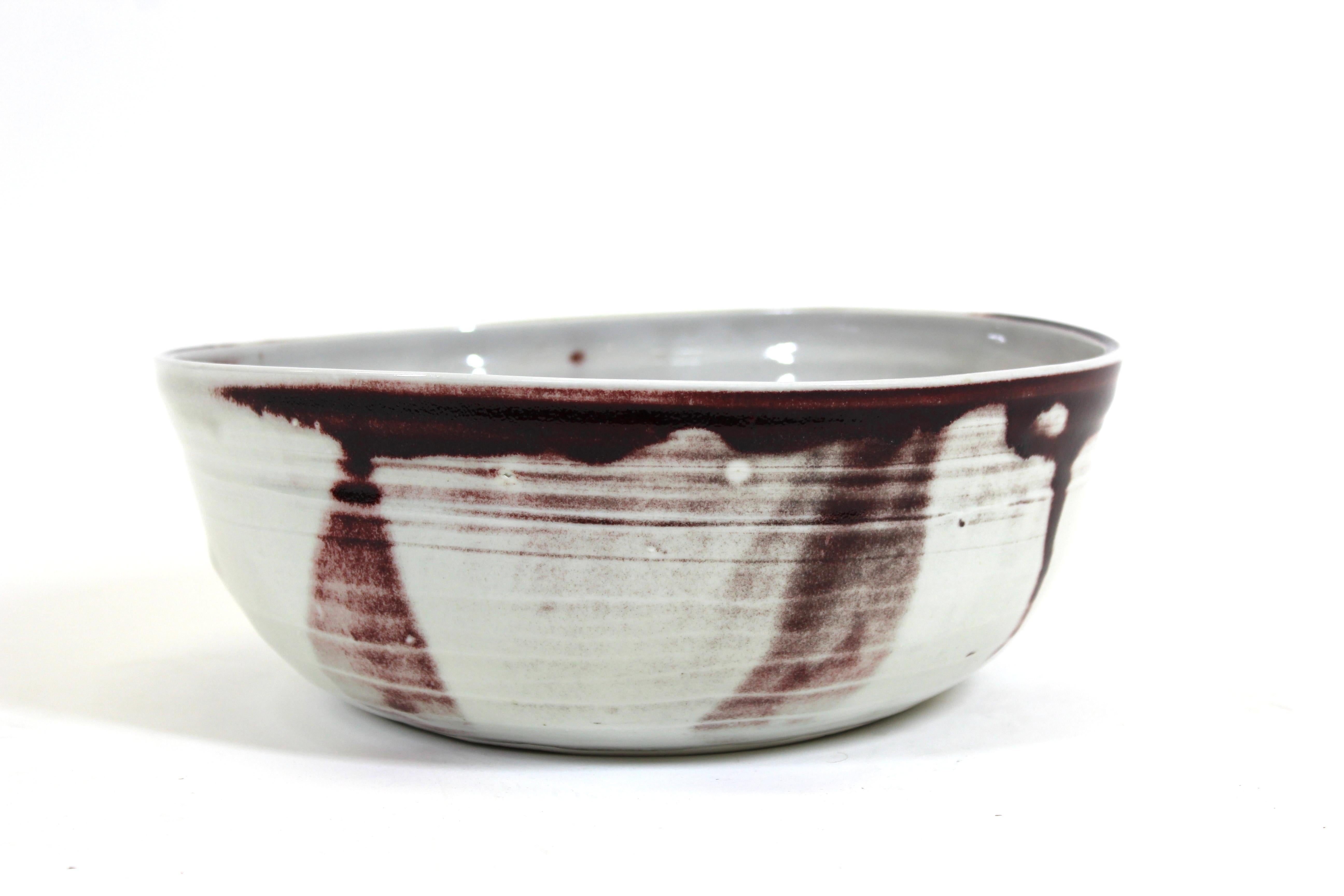 Mid-Century Modern studio ceramic glazed ceramic bowl in aubergine accents, marked 'Earth Art' on the bottom.