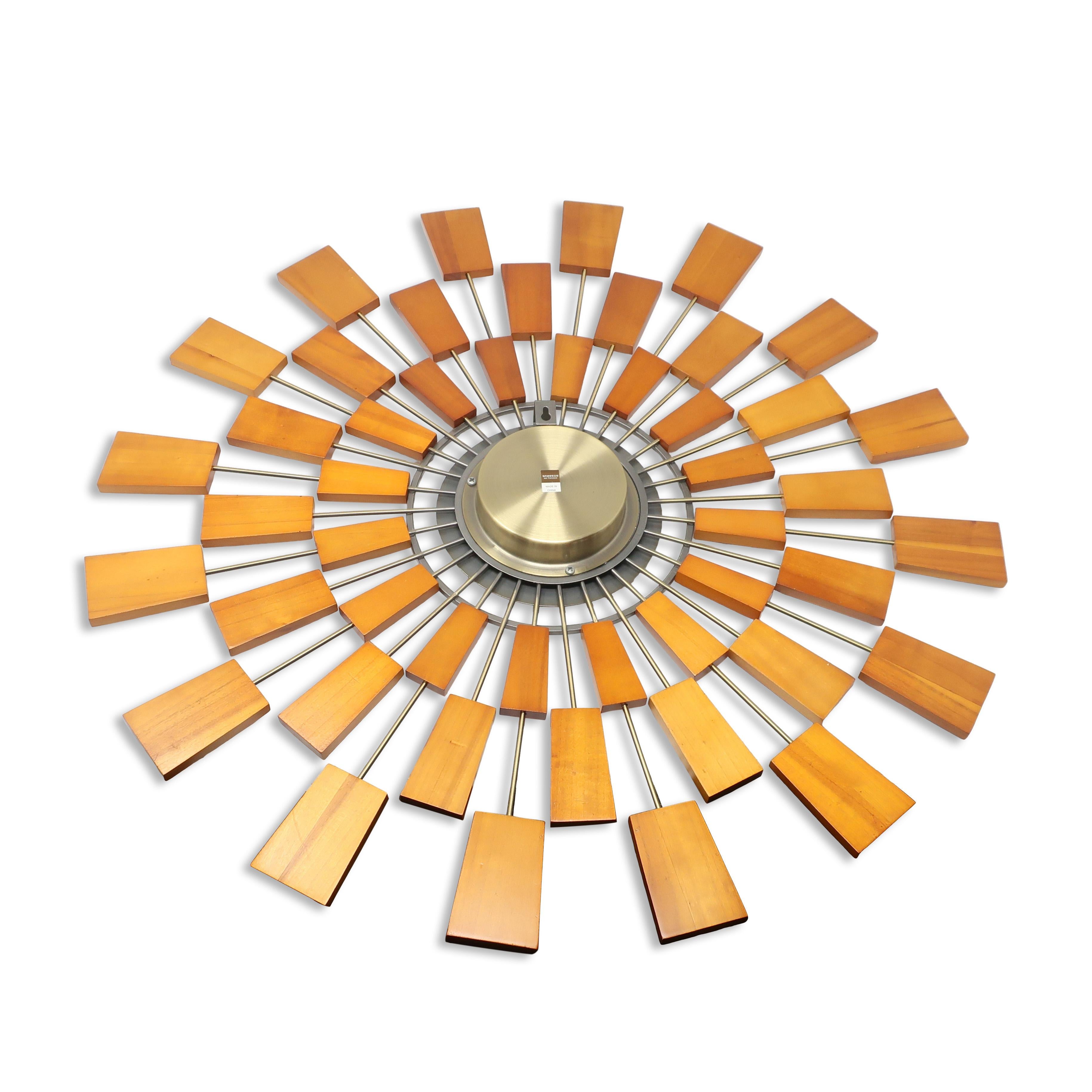 A striking wall clock designed by Kenneth Wingard to evoke the nostalgia of 1950s-style Sunburst clocks we all remember.  Produced in the 2000s, it is a perfect addition to any mid-century modern inspired home.  Features a round form of joined