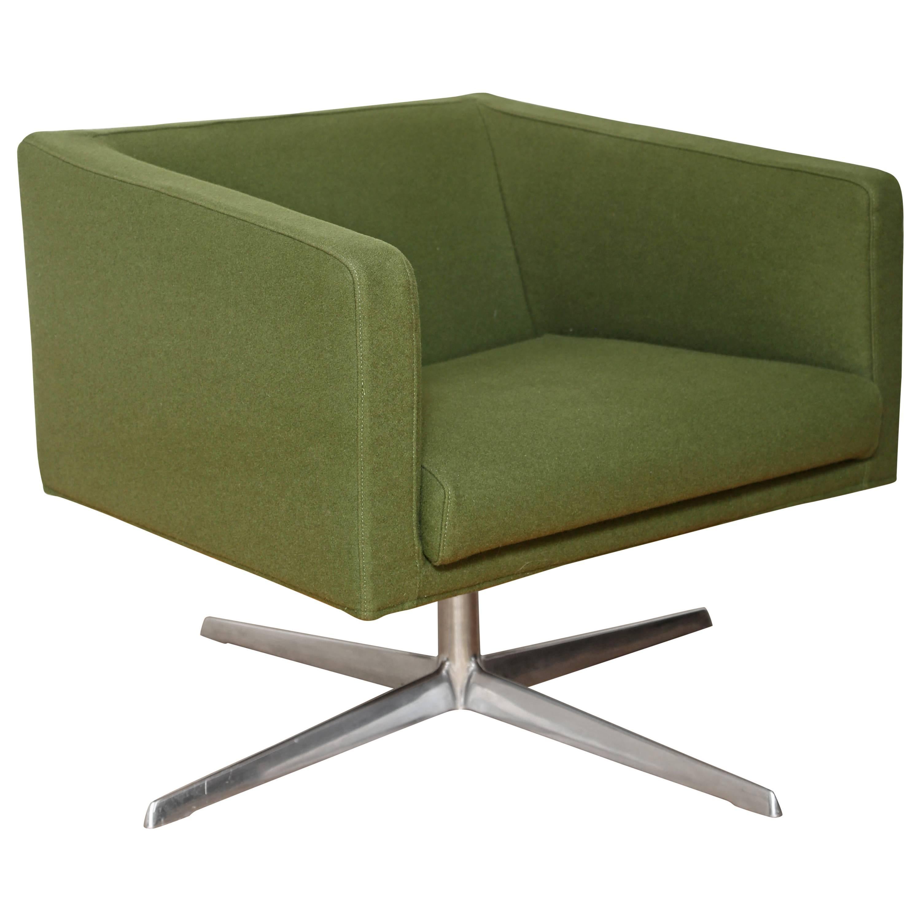 Cubica swivel armchair by Verzelloni. Features Mid-Century Modern design with cubist form, and full 360 degree swivel. Streamline design lends itself to both home or office setting. Upholstered in army green wool blend fabric with four legged