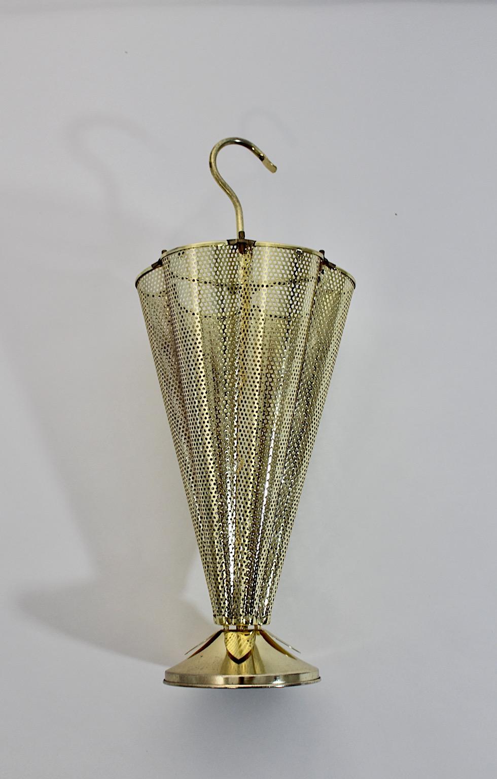Mid Century Modern Style vintage umbrella stand or cane holder 1980s.
A fantastic golden brassed vintage umbrella stand or cane holder with a conical shaped body from perforated brassed iron formed like an umbrella.
With a circular base decorated